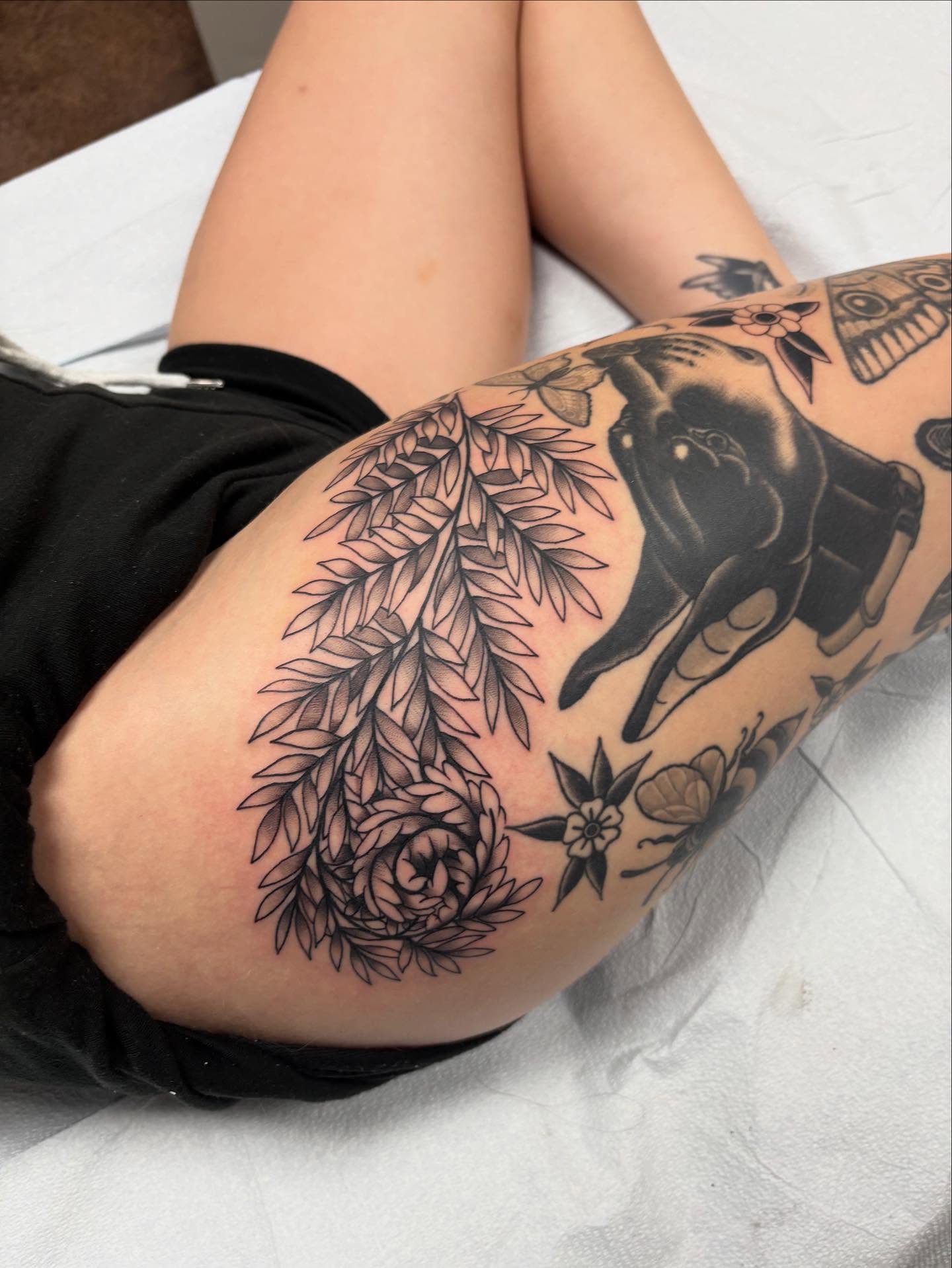 Elephant and floral black and grey tattoo on the thigh by Jakob Ristau, Kansas City, Missouri