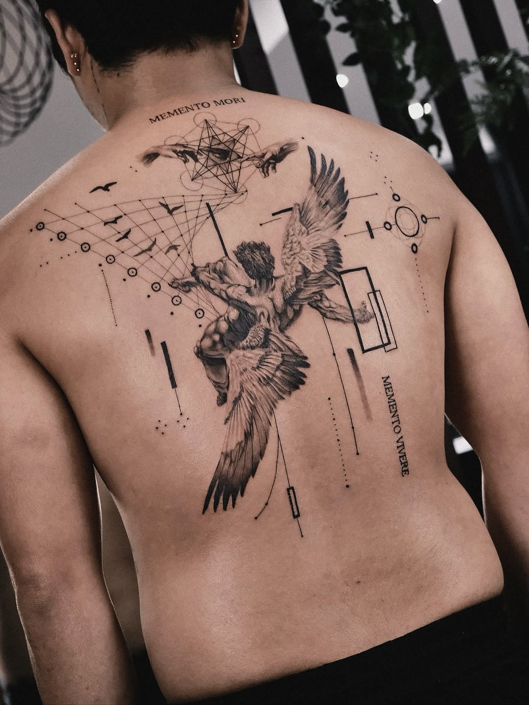 Angel with geometric elements and birds realism tattoo on the back by Seraph Geometry