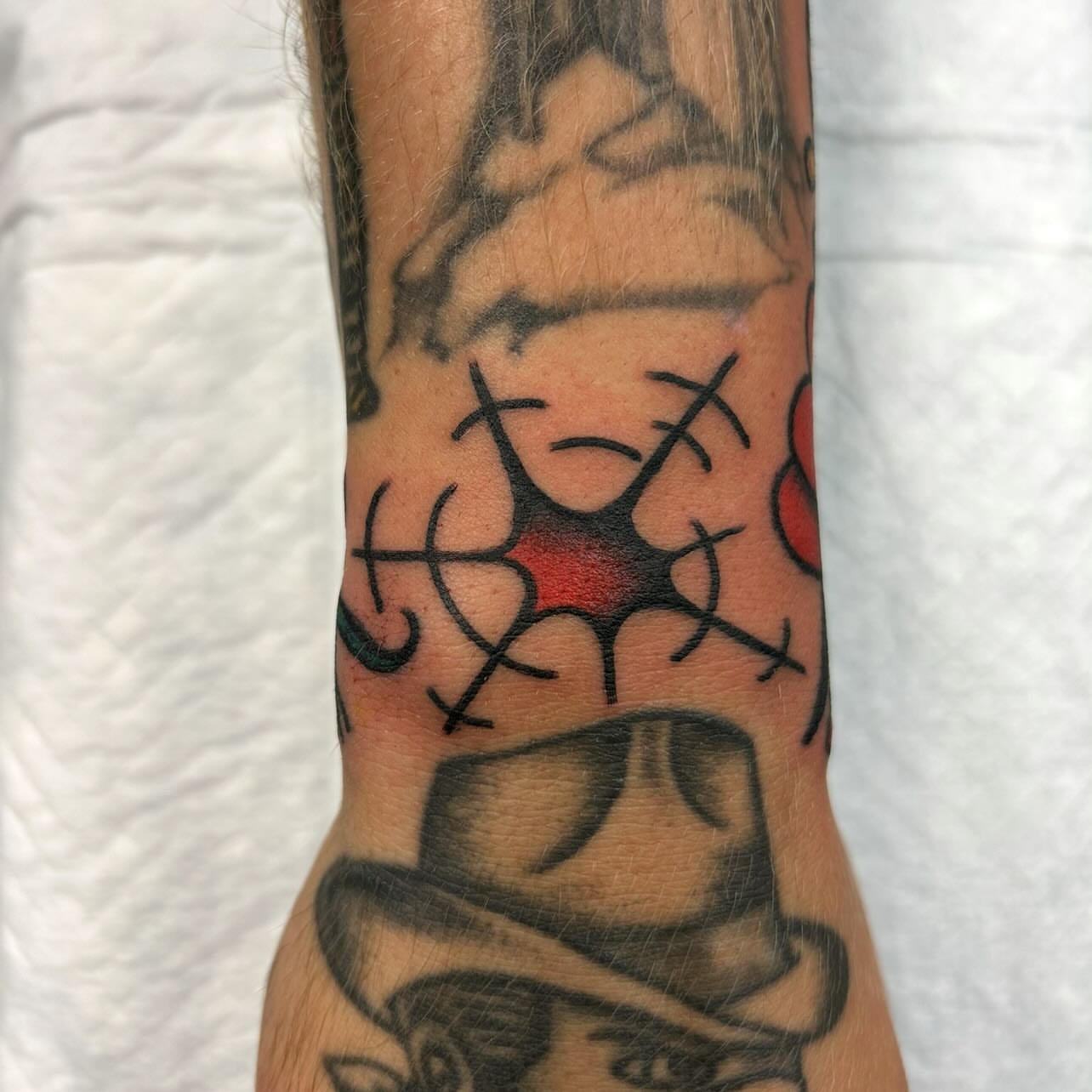 Stitch pattern black and grey tattoo on the forearm by Atom Aker