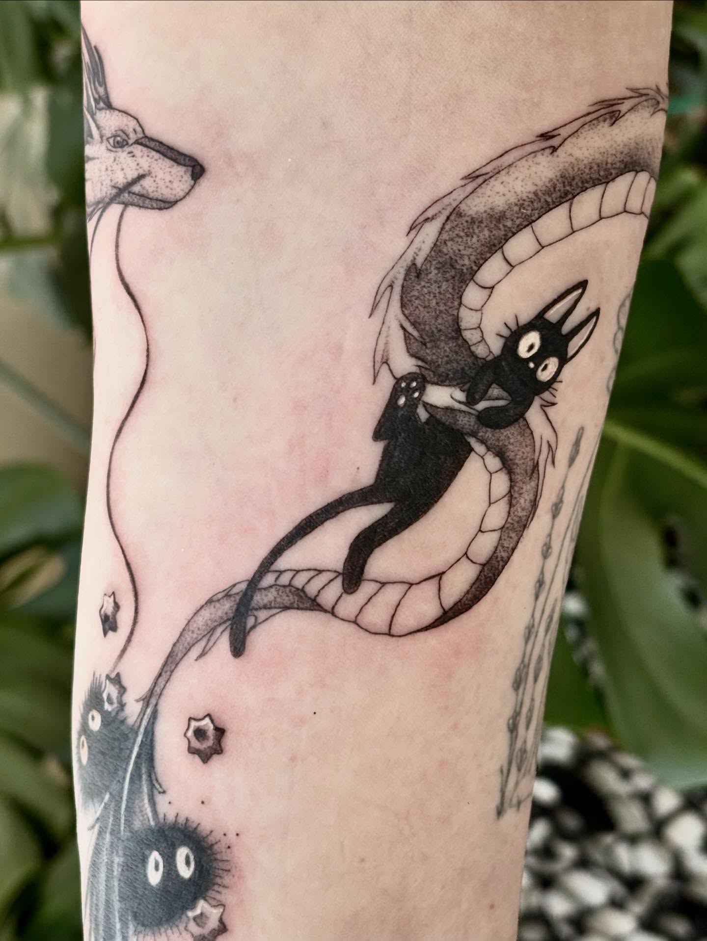Cat riding snake anime tattoo on the forearm by Jazzlyn Hous