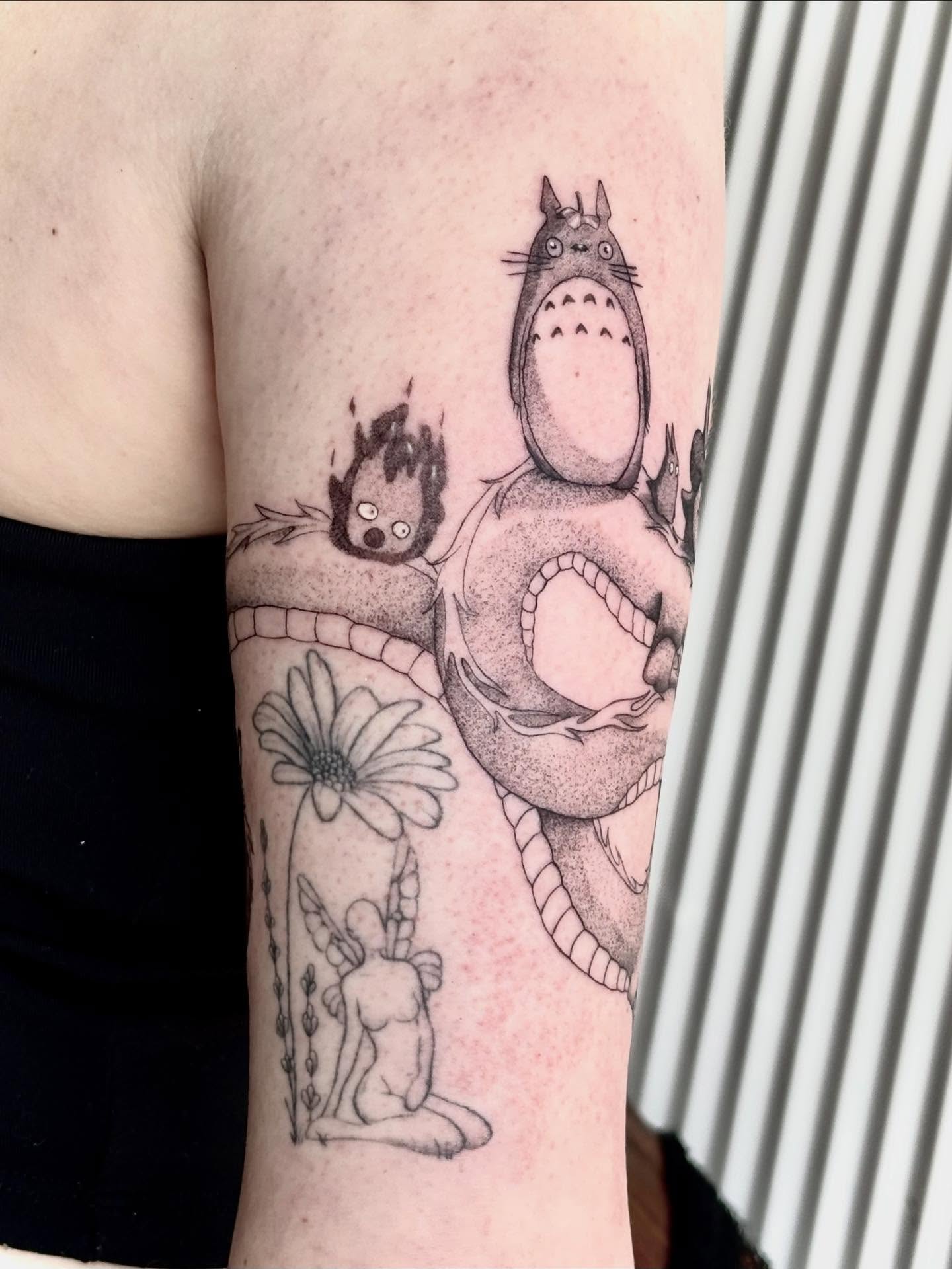 Totoro and fire spirit dotwork tattoo on the forearm by Jazzlyn Hous