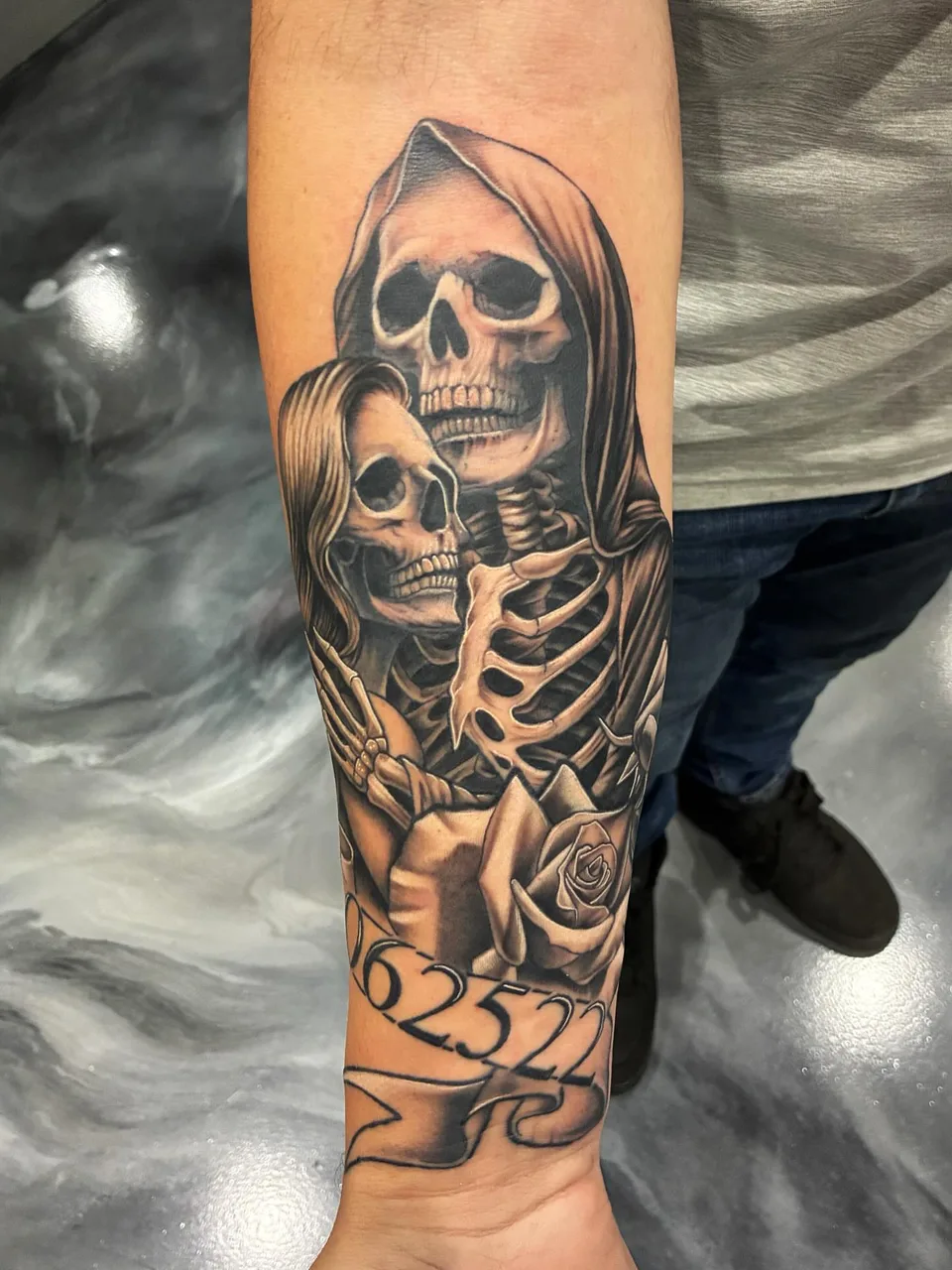 Skeleton couple realism tattoo on the forearm by Adam Silfies