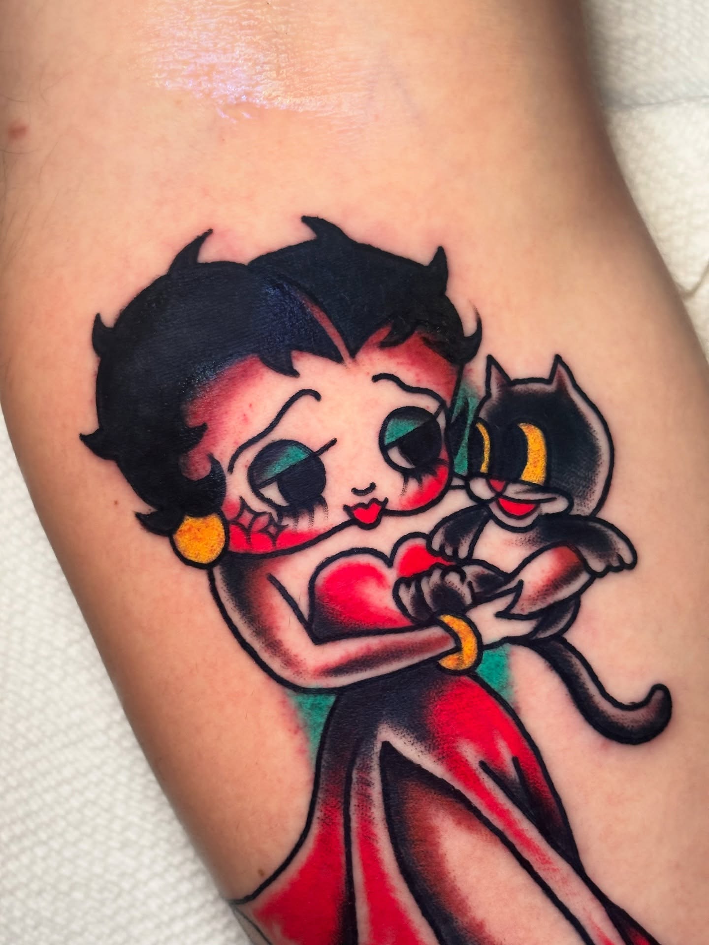 Betty Boop and cat American traditional tattoo on the thigh by Nick