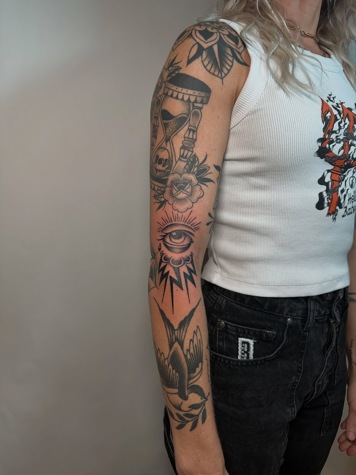 Eye and rose American traditional tattoo on the forearm by Heather Cherish