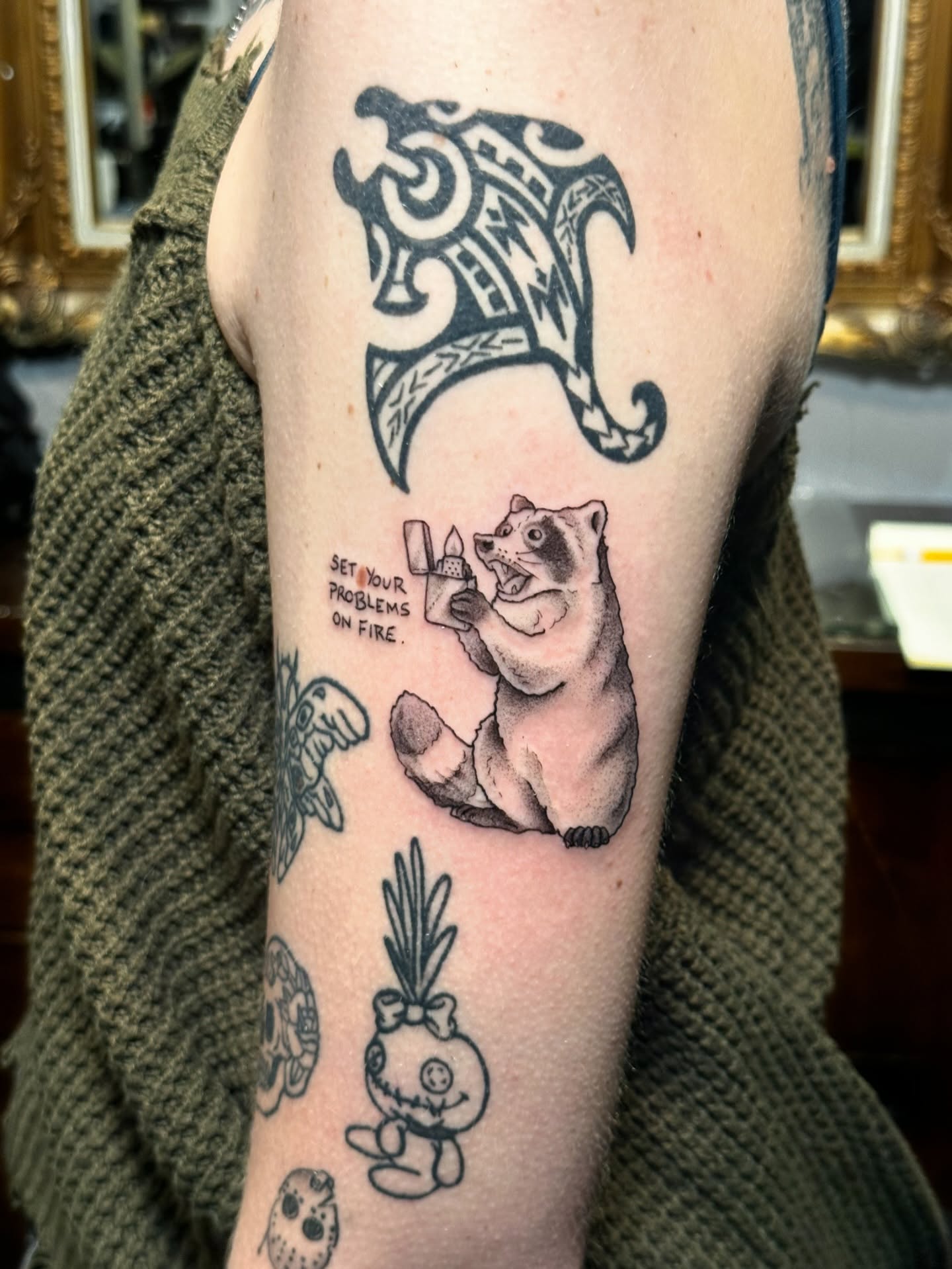 Bear holding lighter realism tattoo on the forearm by James Nelson