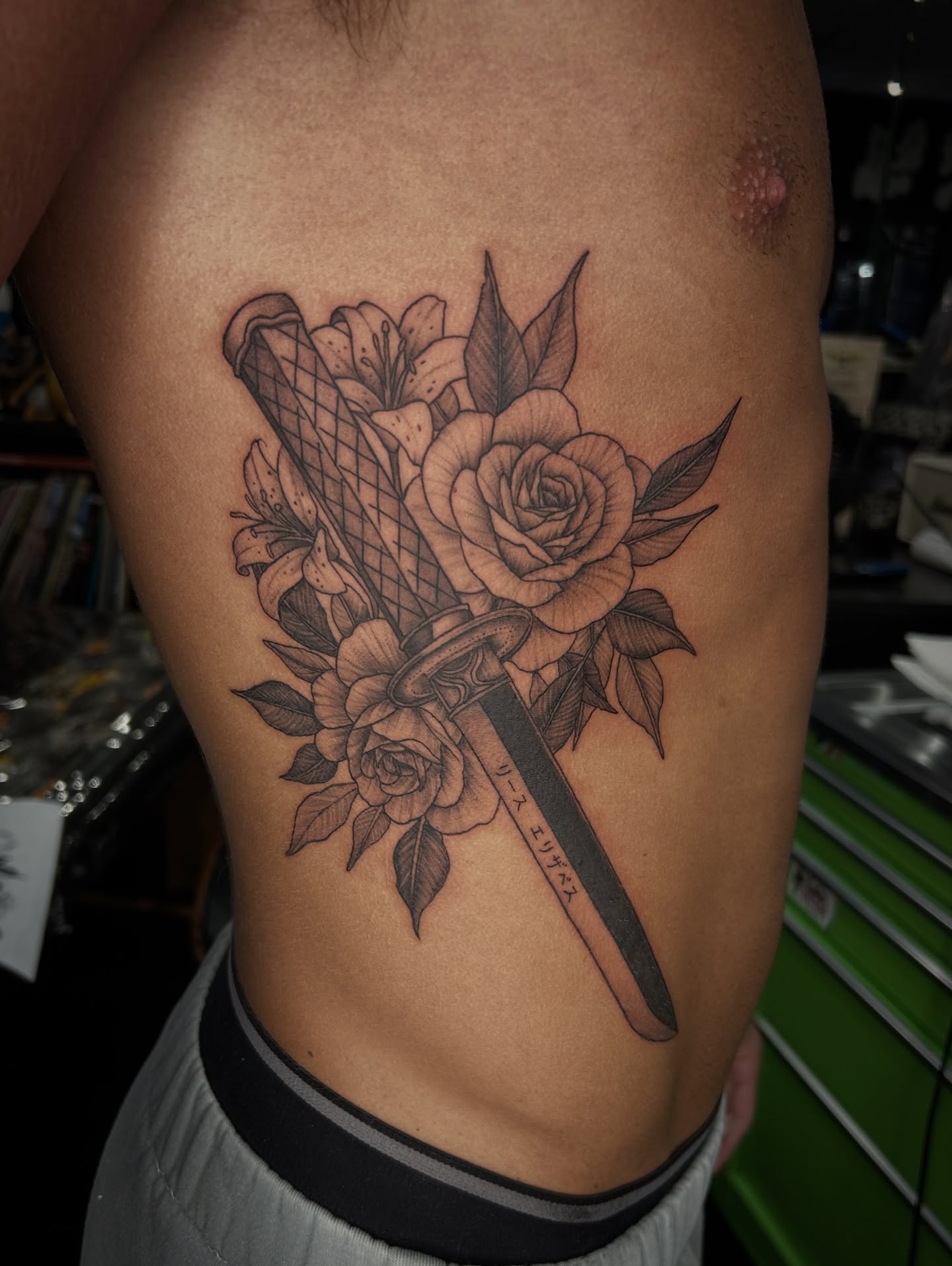 Sword and flowers realism tattoo on the ribs by Austin C Pratt-Fusari