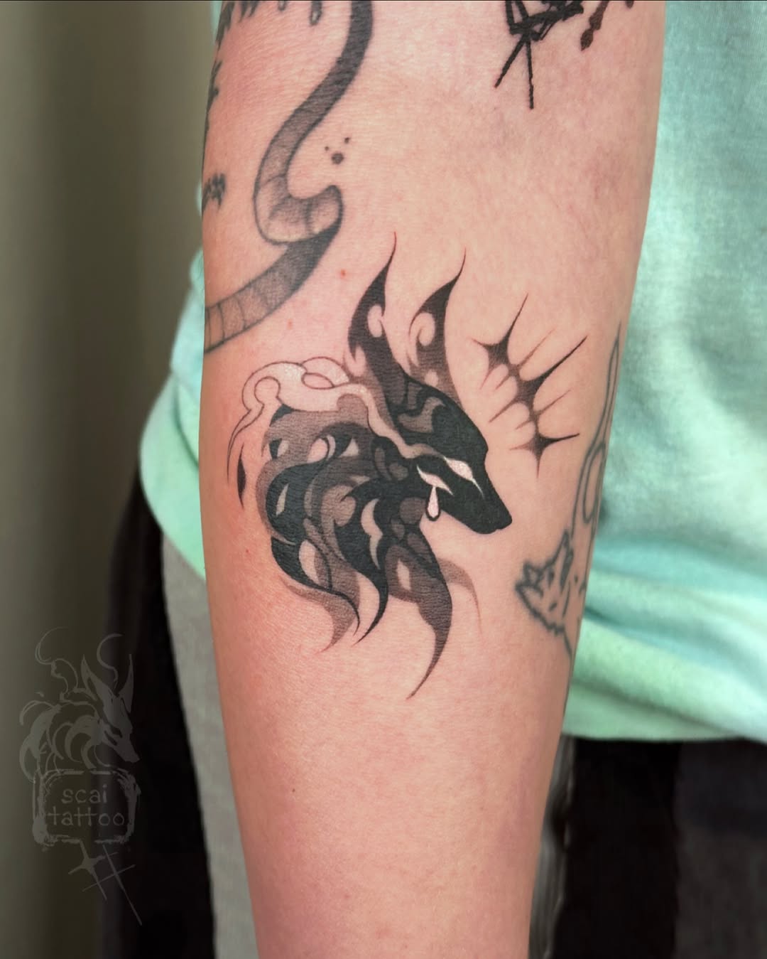 Wolf head with flame-like mane cyber sigilism tattoo on the forearm by scaitattoo