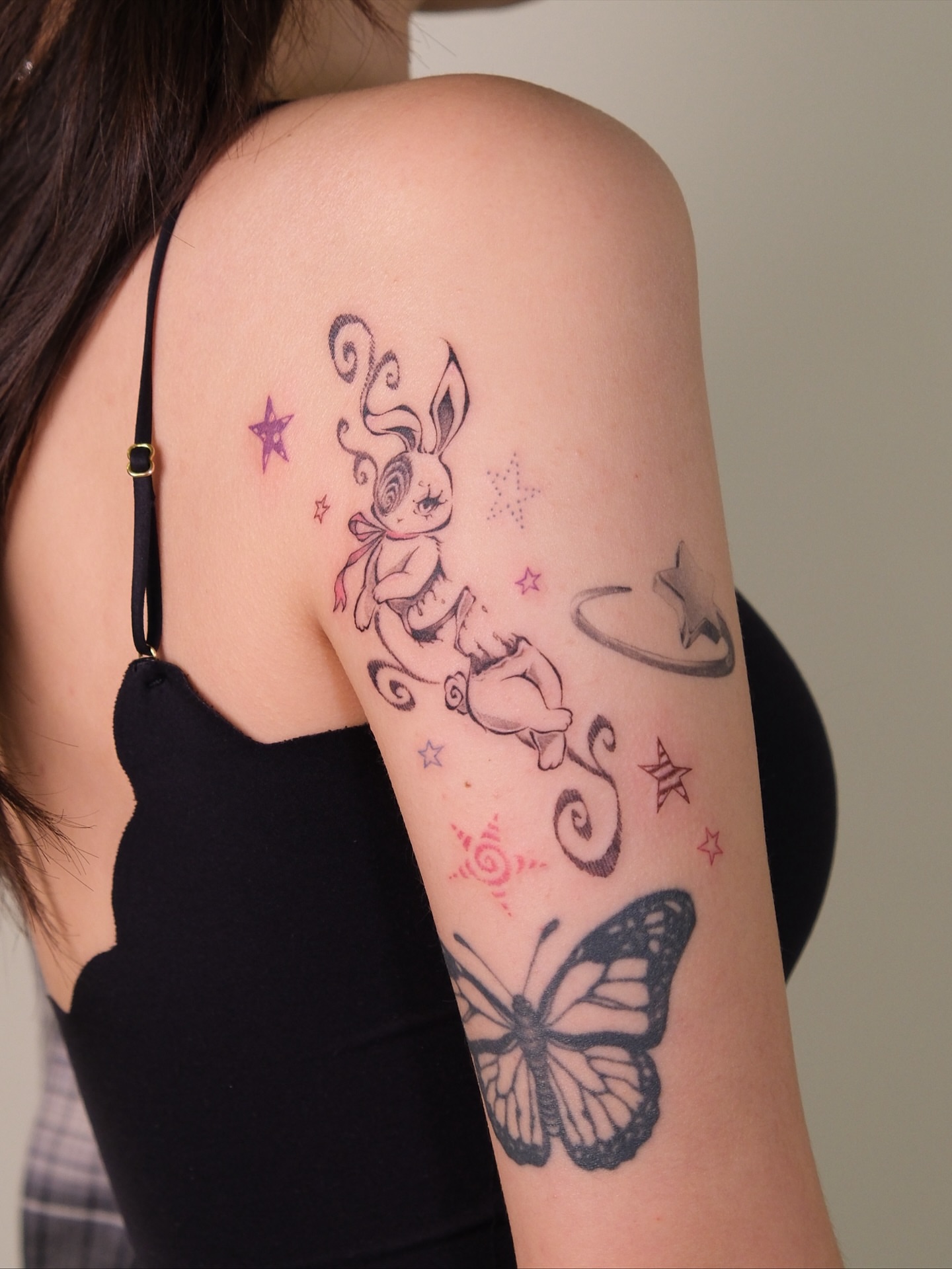 Bunny and butterfly new school tattoo on the upper arm by ââŪ. Ý ðķðð―ððð âðĶđËâ seattle tattoo artist, Seattle, Washington