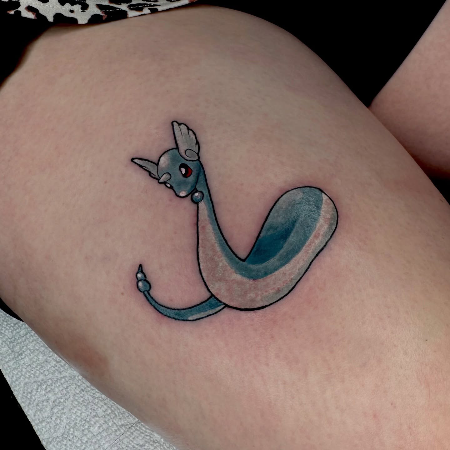 Dragon dotwork tattoo on the thigh by Brett Brown