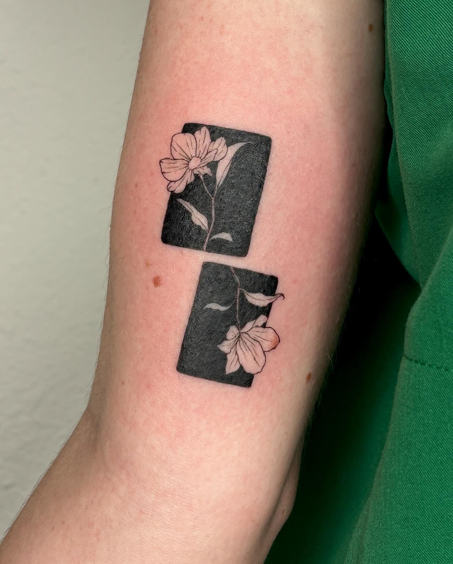 Flower and card black and grey tattoo on the forearm by alyssa doing tattoos
