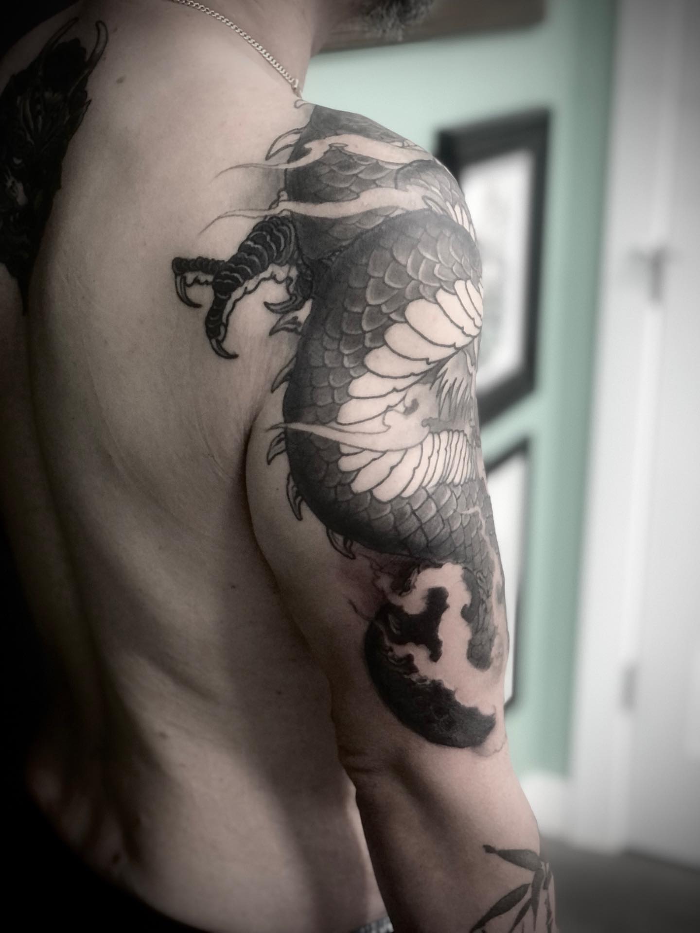 Koi fish black and grey tattoo on the shoulder by Alec Bauer