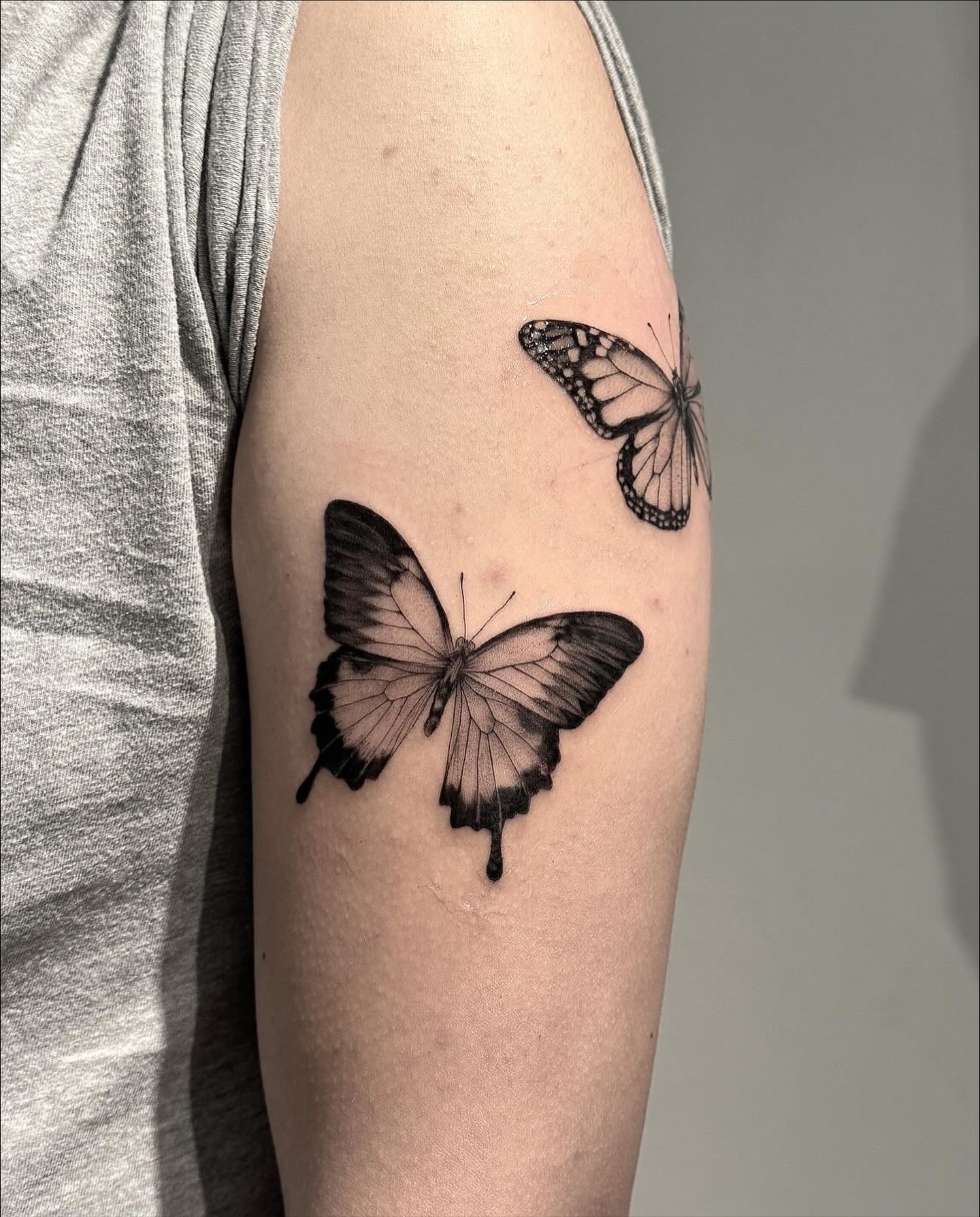 Butterflies black and grey tattoo on the forearm by Jasmine, Lynnwood, Washington
