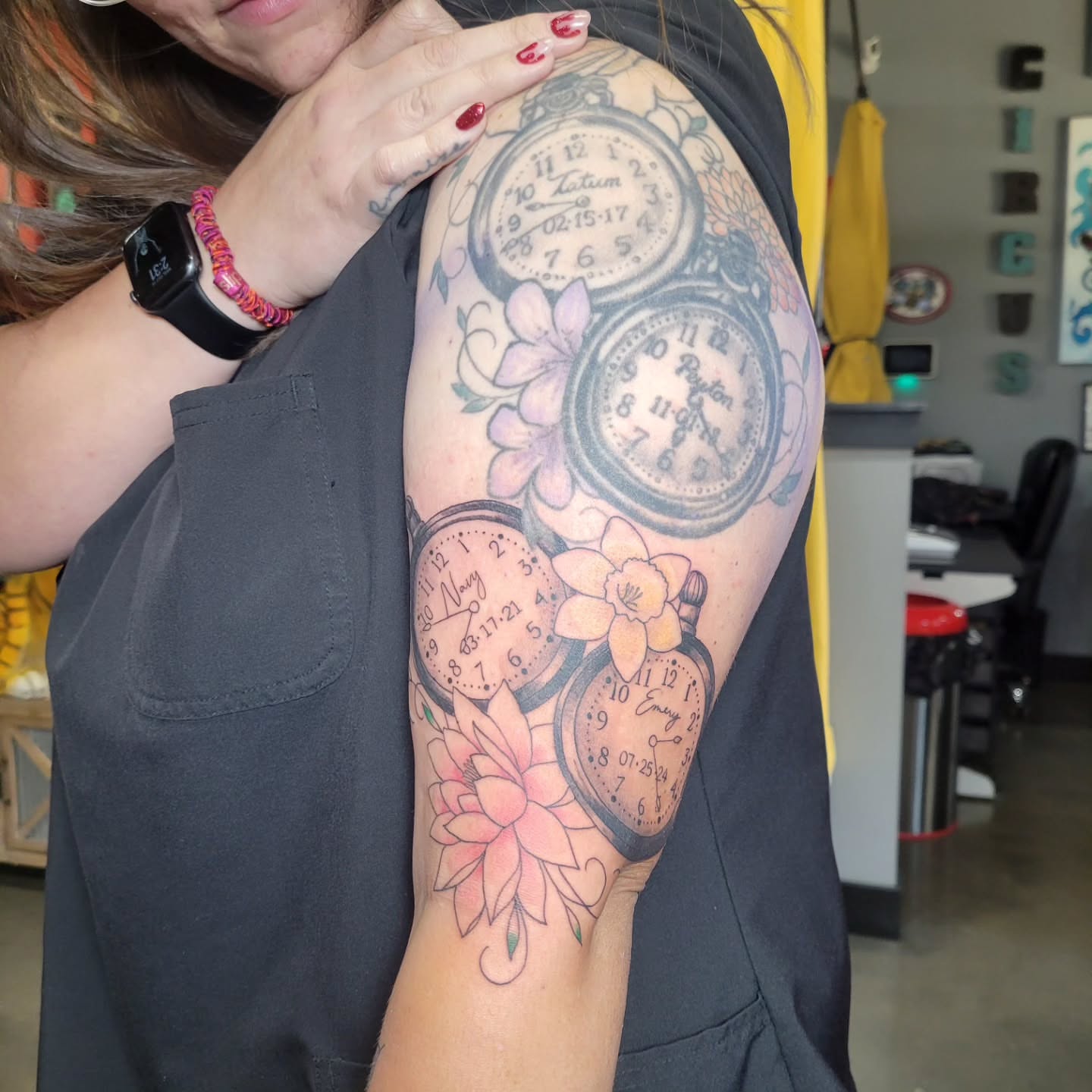 Clocks and flowers black and grey tattoo on the shoulder by Aspen C