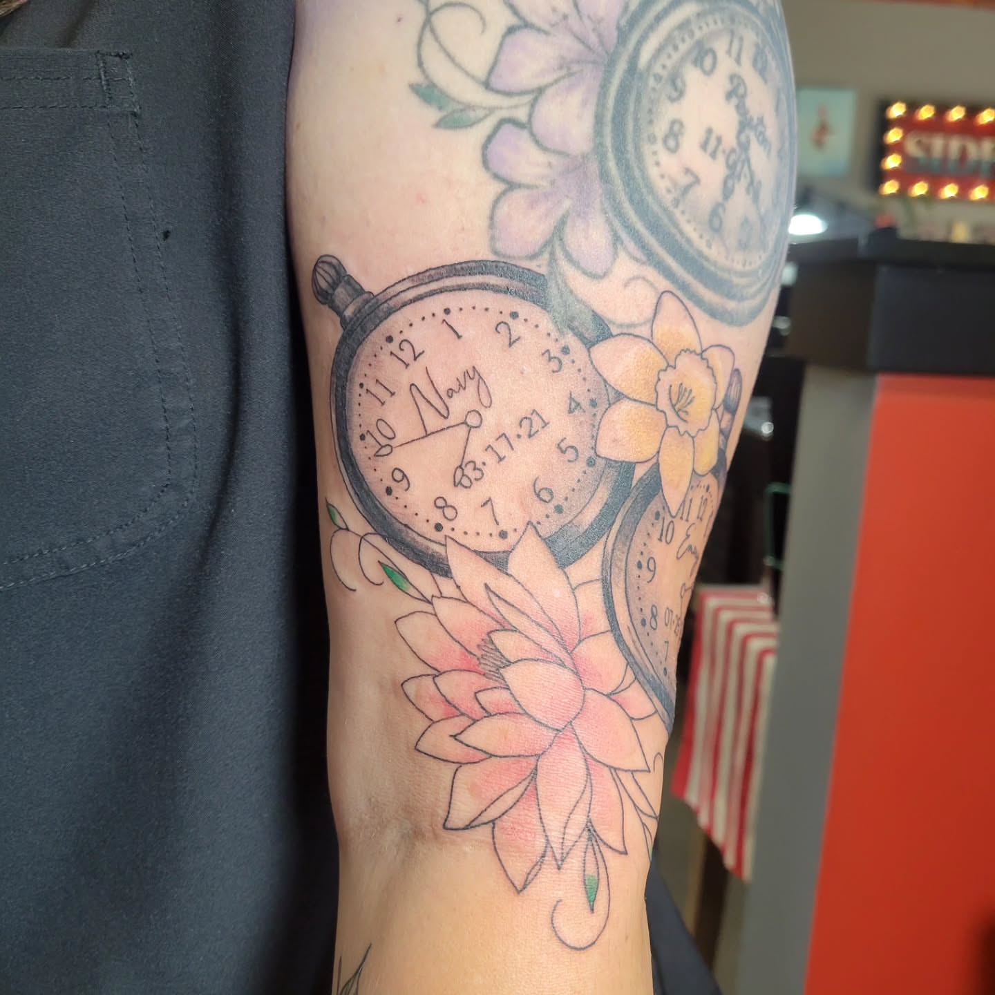 Clock and flowers realism tattoo on the forearm by Aspen C
