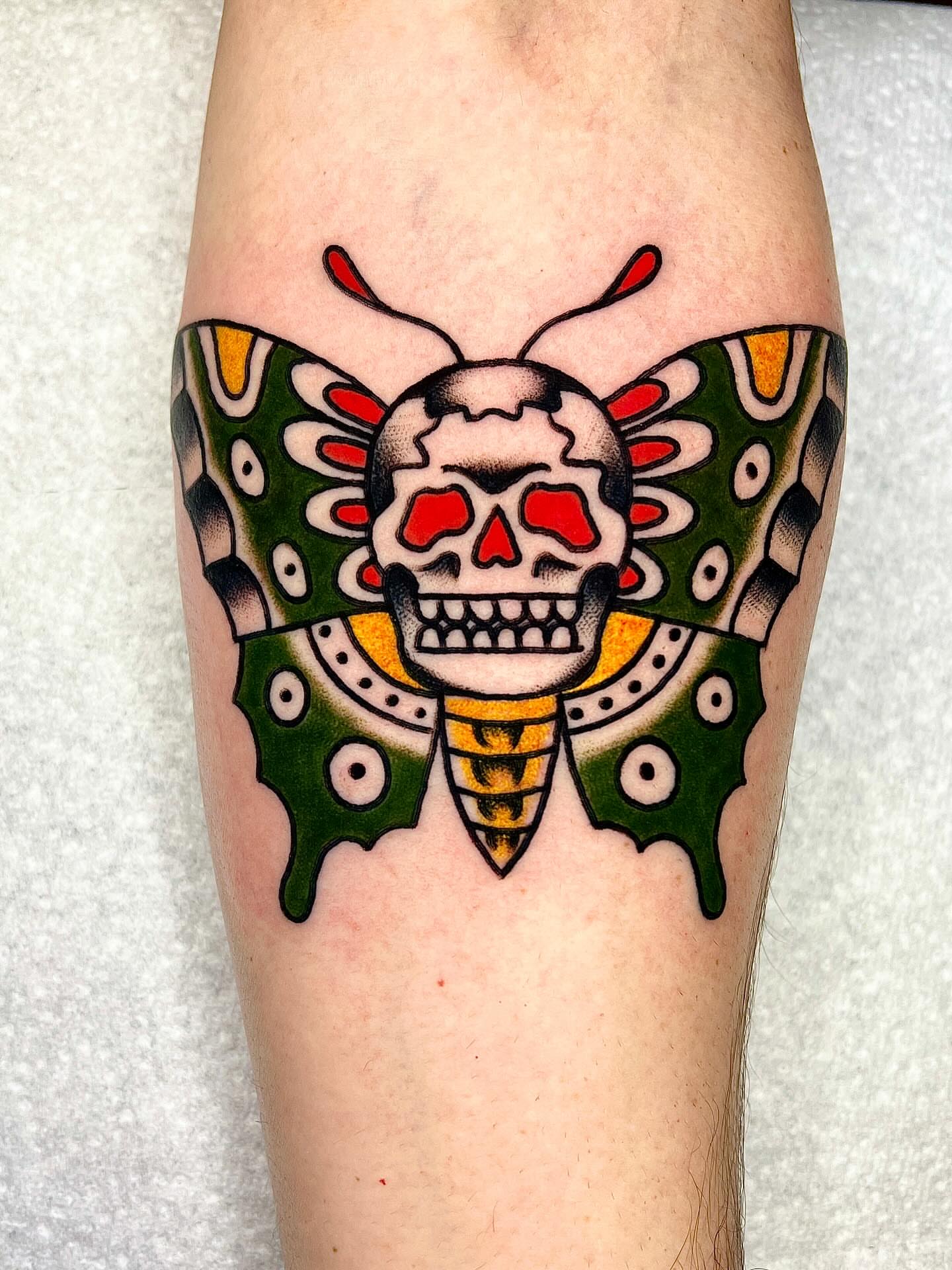 Skull and butterfly American traditional tattoo on the forearm by ReadyFreddie_tattoo