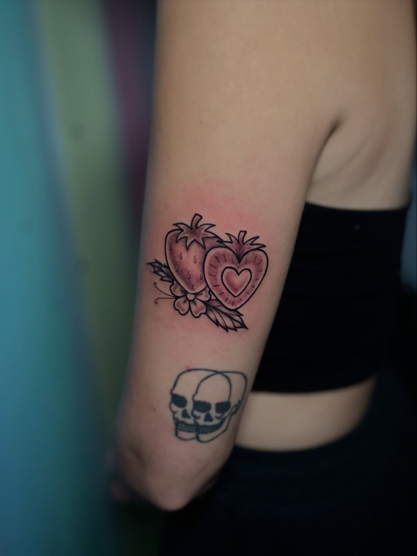 Strawberries and heart American traditional tattoo on the forearm by Liv