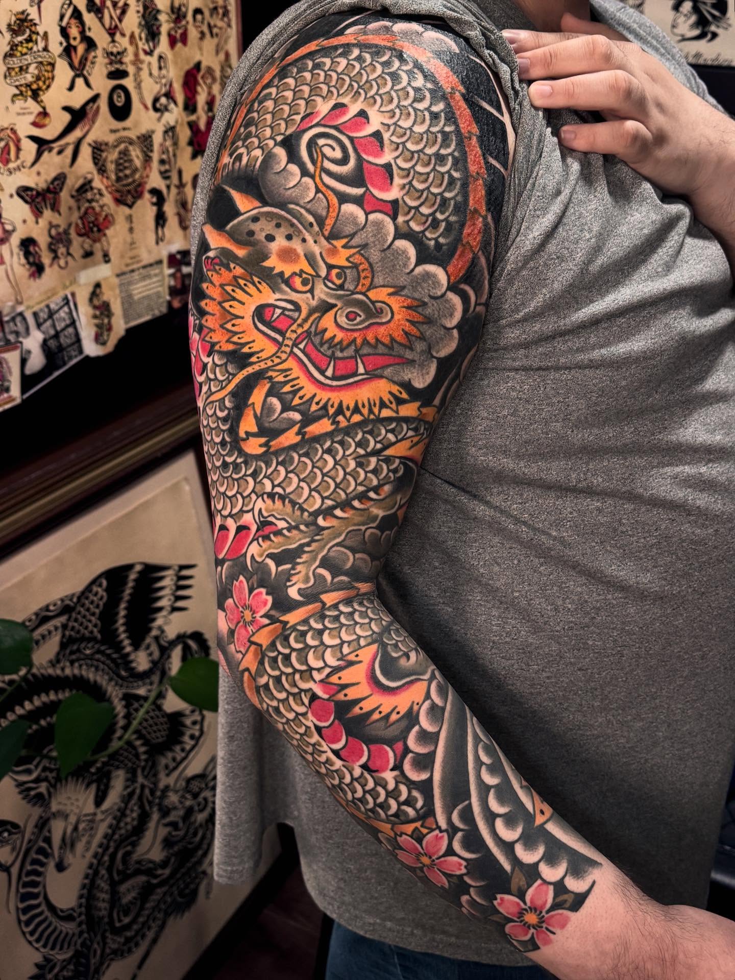 Dragon and flowers japanese irezumi tattoo on the upper arm by Ryan Engels