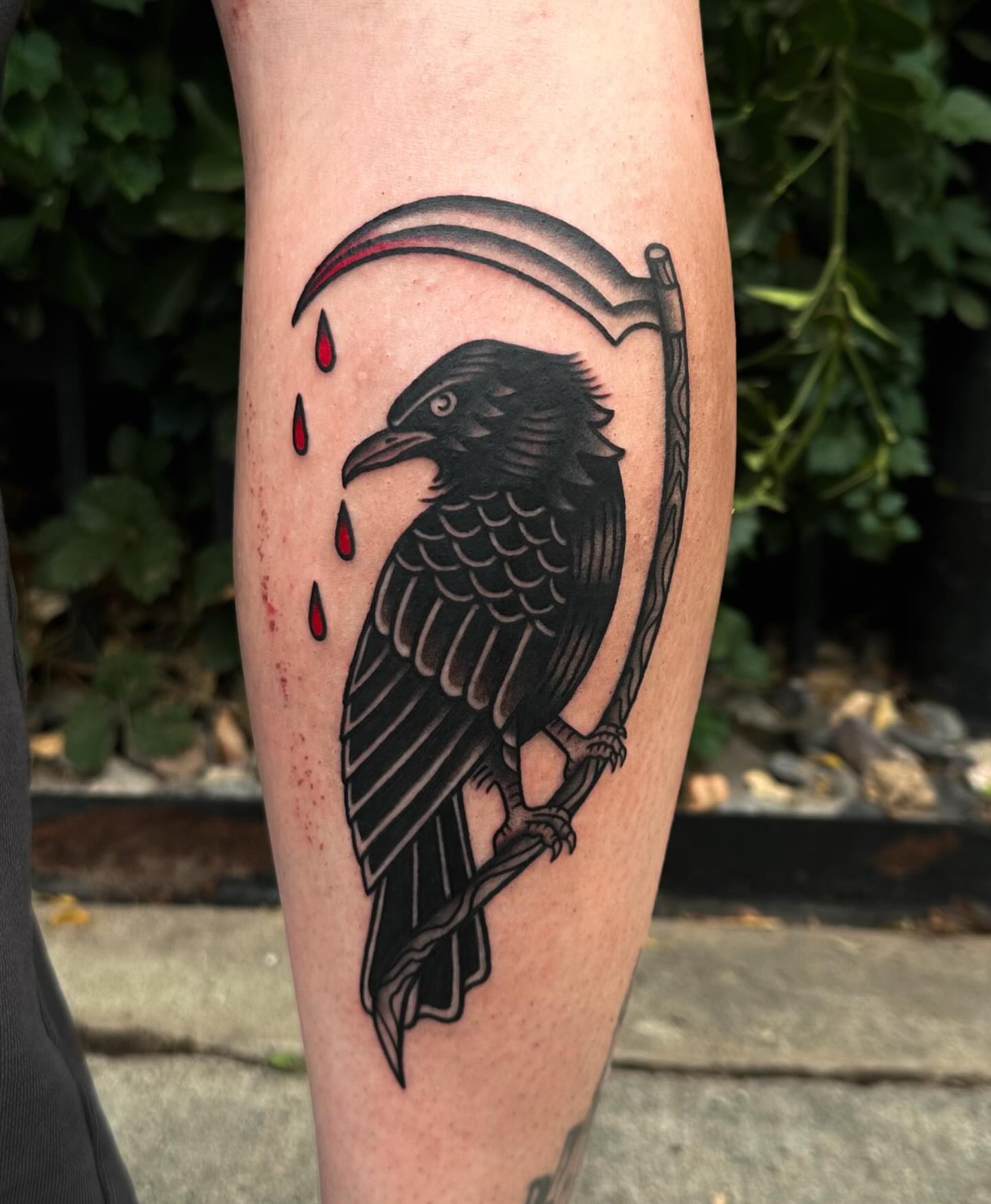 Crow and scythe black and grey tattoo on the forearm by Gabby Tolley🌛