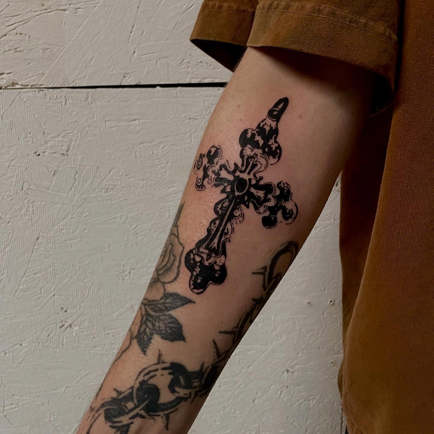Cross black and grey tattoo on the forearm by bisabuelita