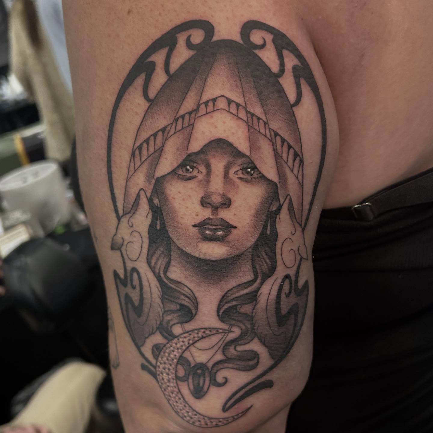 Woman with hood realism tattoo on the forearm by Whitney Harbin