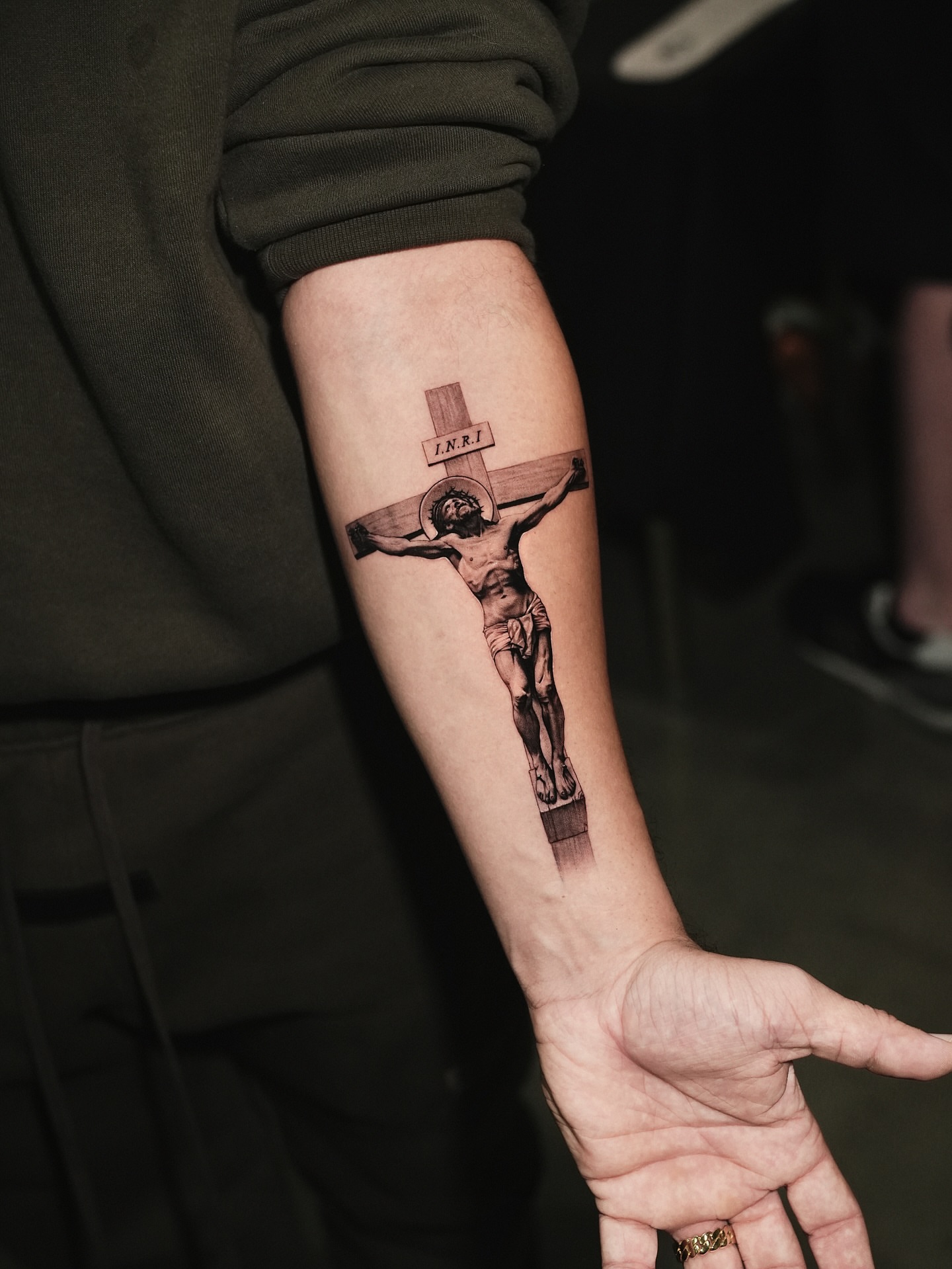 Crucifixion scene black and grey tattoo on the forearm by Kid Needle