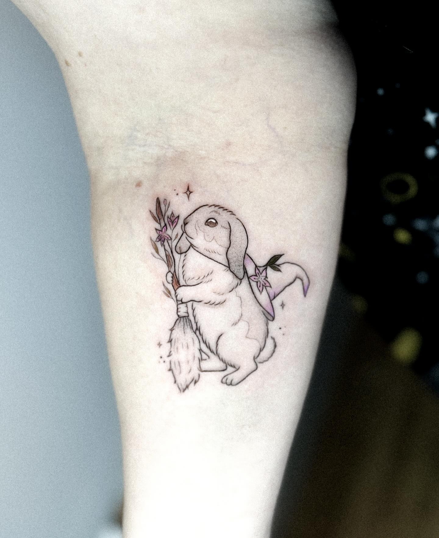 Rabbit with broomstick dotwork tattoo on the forearm by Whimsical Tattoos