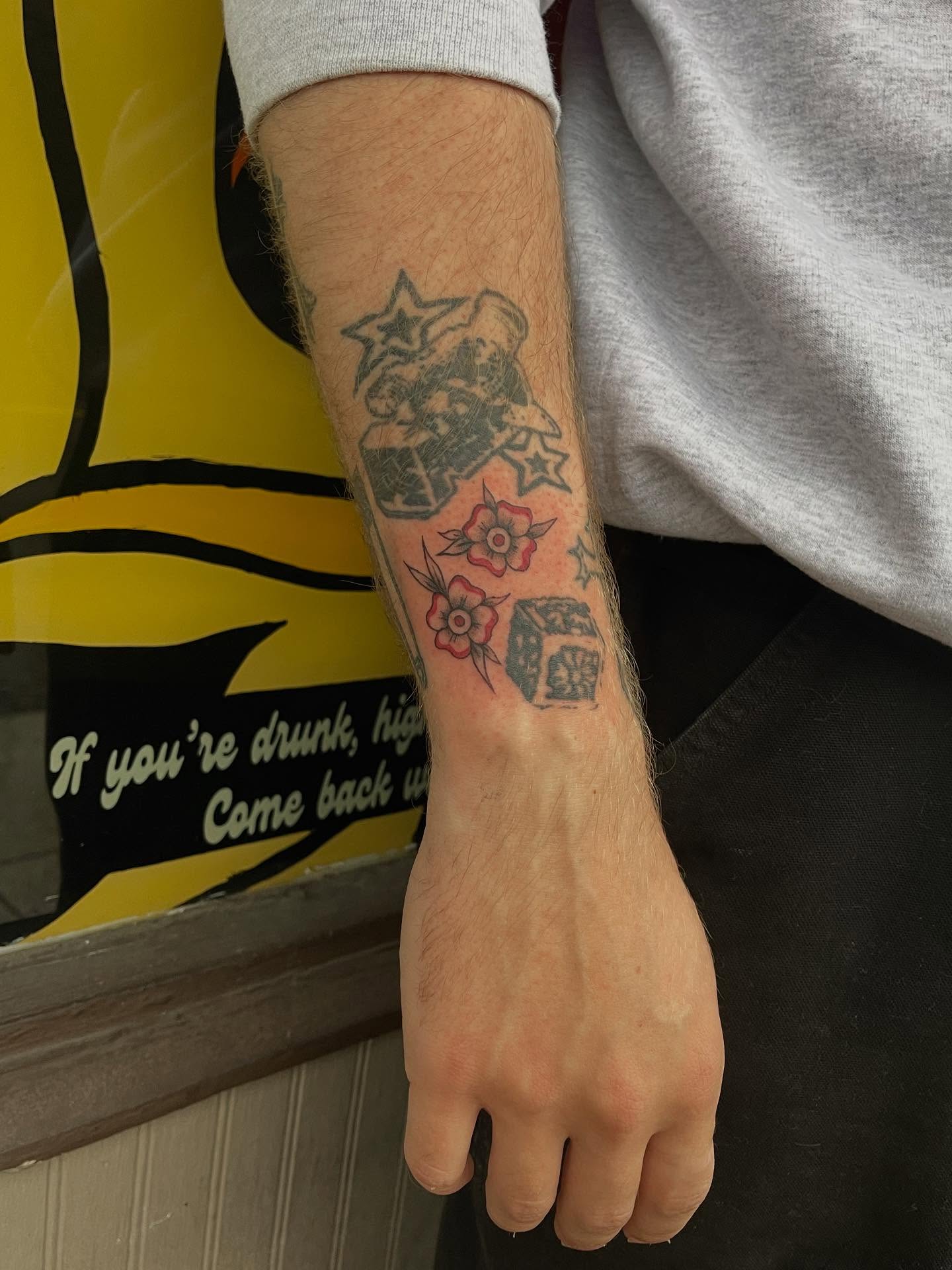 Flowers and dice American traditional tattoo on the forearm by J❄️, Portland, Oregon