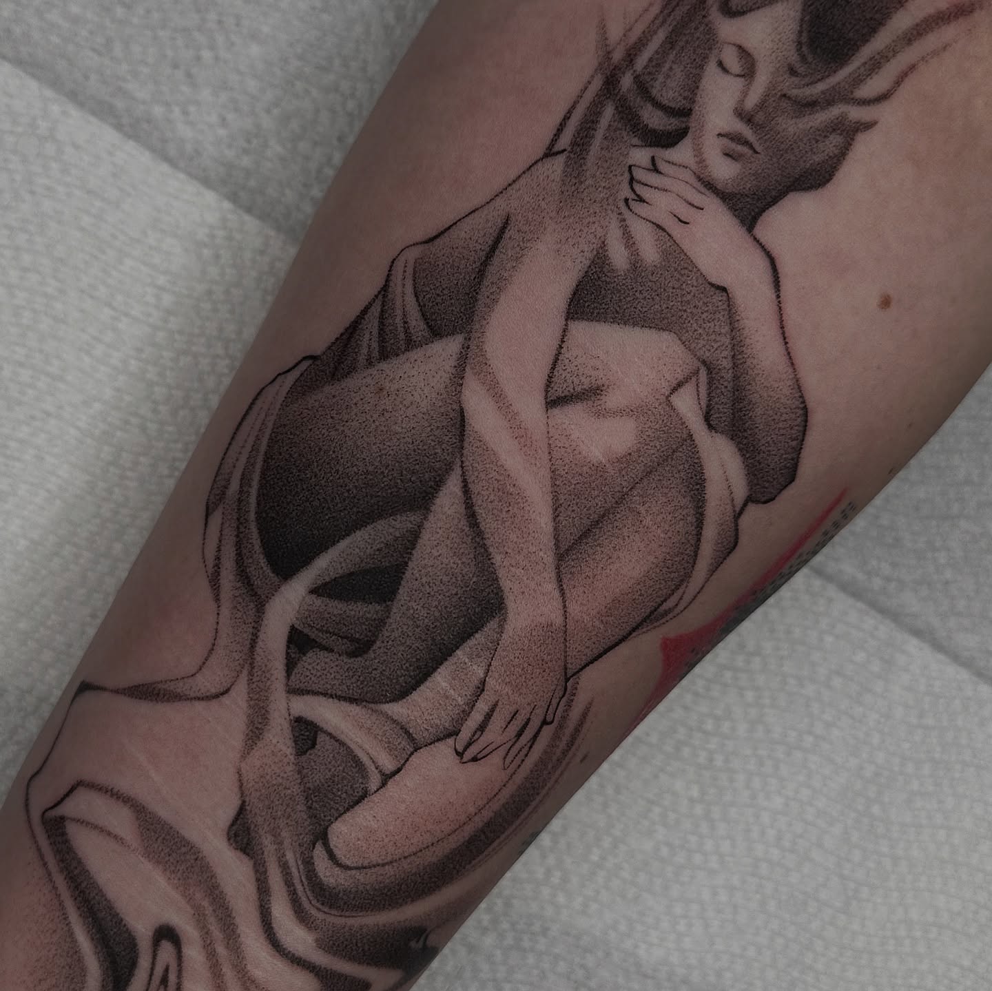 Nude woman dotwork tattoo on the forearm by Cheyenne Shoffner