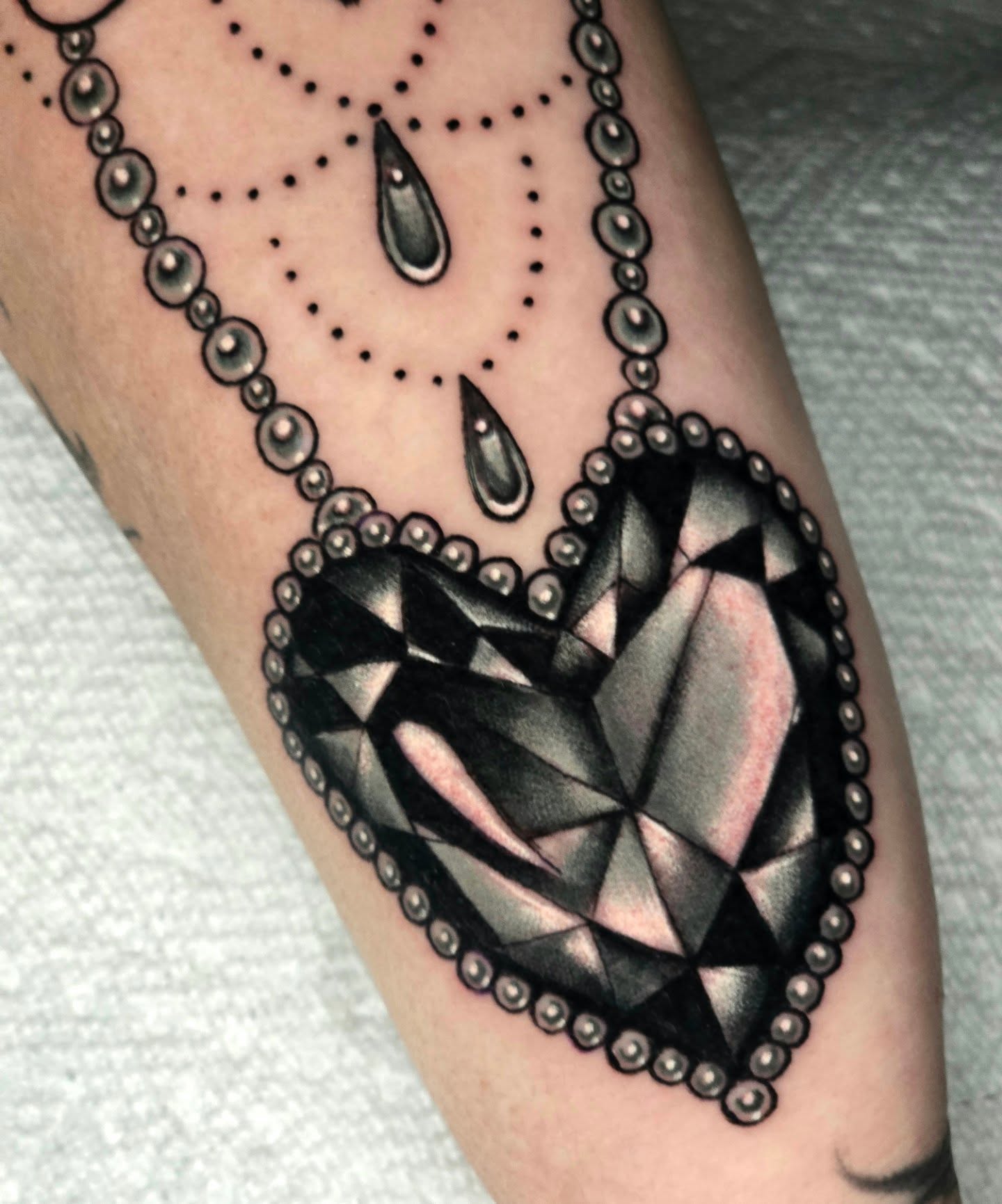 Heart with diamond geometric tattoo on the forearm by Adison Essig