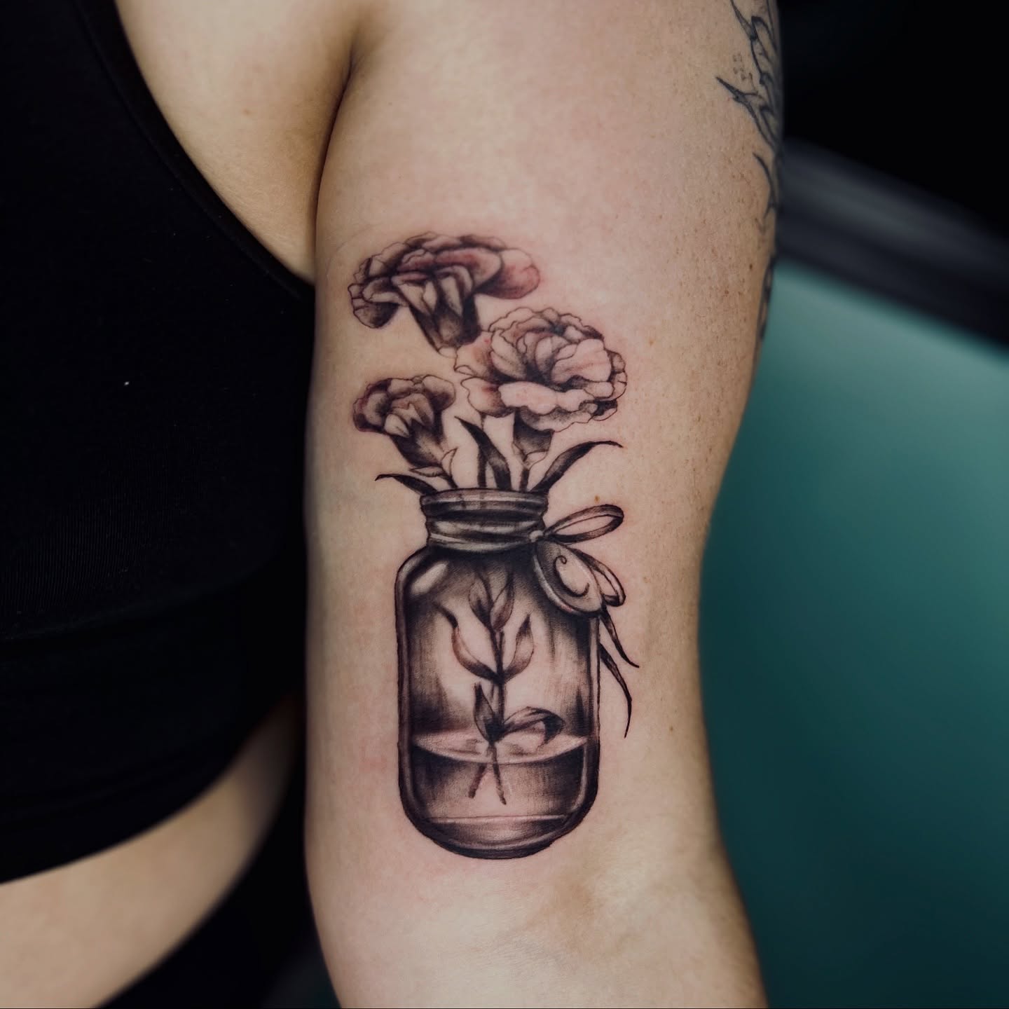 Flowers in jar black and grey tattoo on the forearm by Sydney Rose