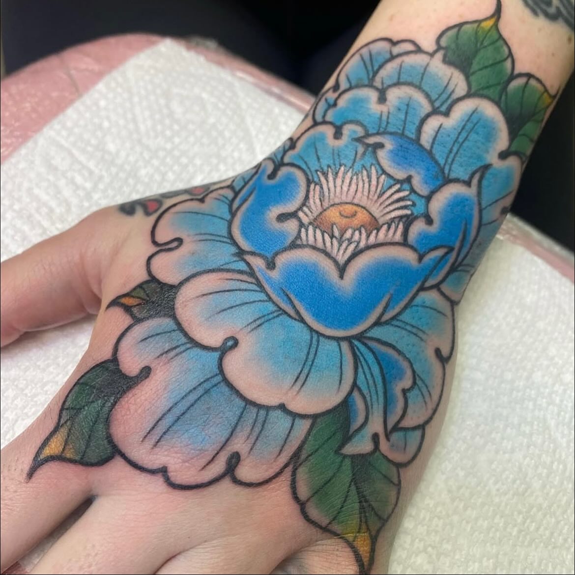 Blue flower American traditional tattoo on the hand by Vivian HavaTattoo, Richmond, Virginia