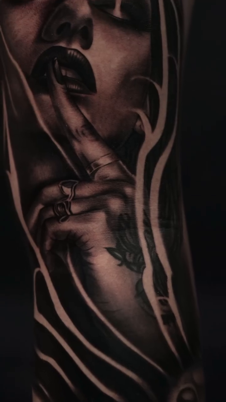 Woman with finger to lips realism tattoo by Michael Sosa