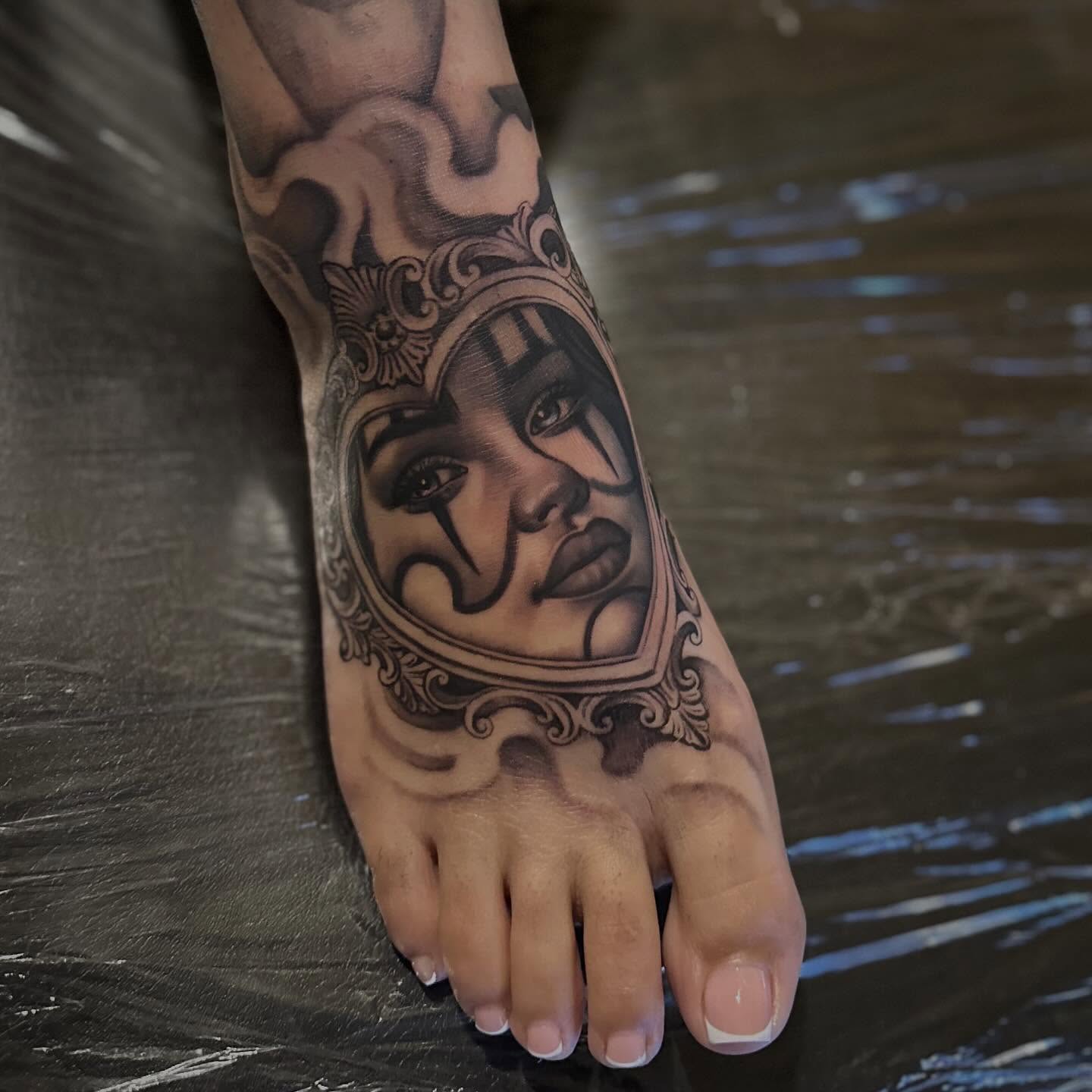 Woman's face realism tattoo on the foot by 𝒲𝒾𝓃𝑜𝓃𝒶