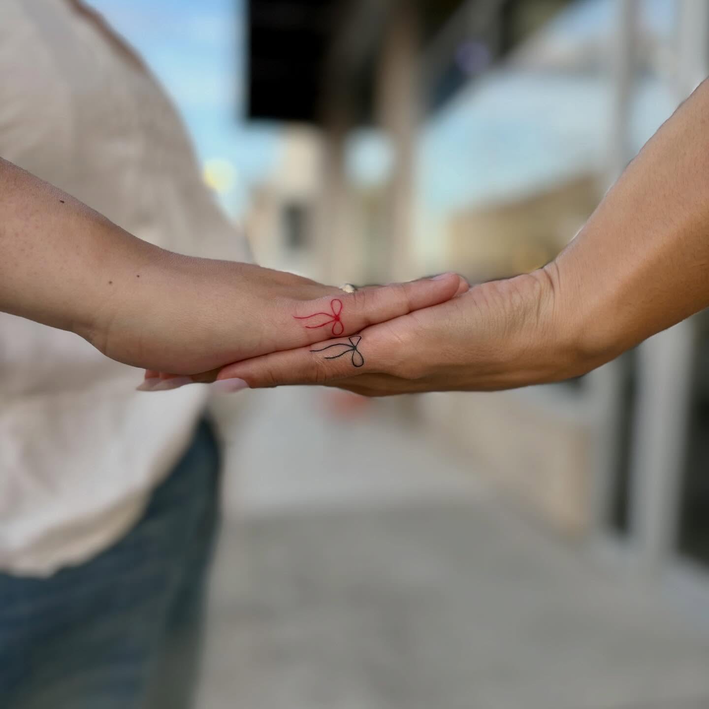 Bow fine line tattoo on the hand by bradyn thornton: eco-tattoo artist