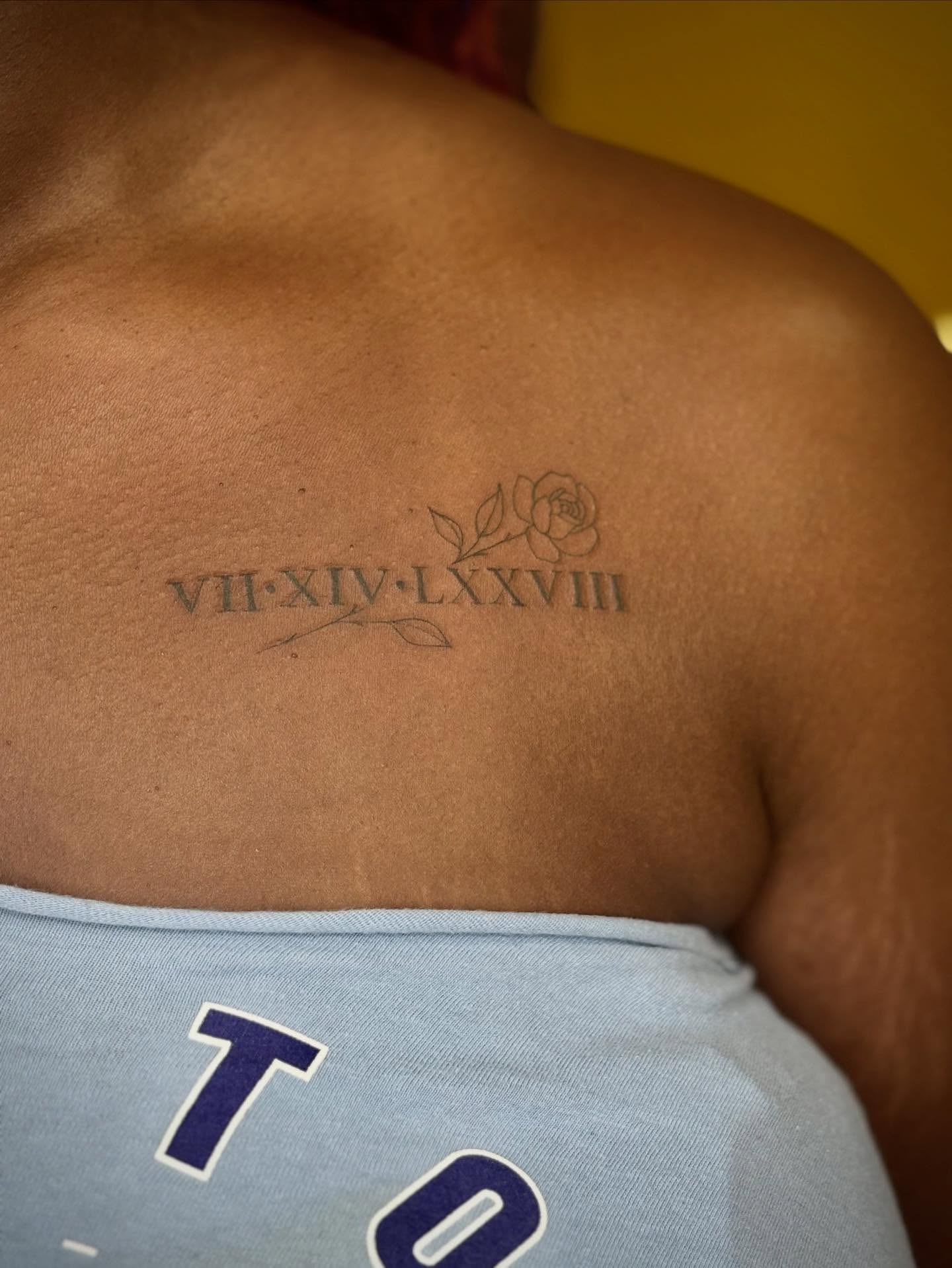 Roman numerals and rose black and grey tattoo on the back by Jazzlyn Hous