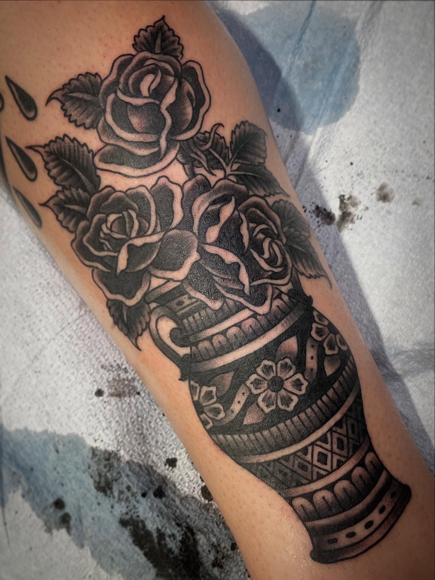Roses and vase black and grey tattoo on the forearm by Haley McMahon