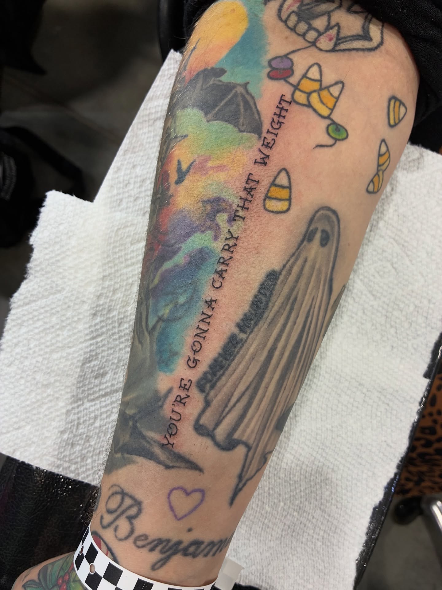 Ghost and candy corn American traditional tattoo on the forearm by Lance 🦈