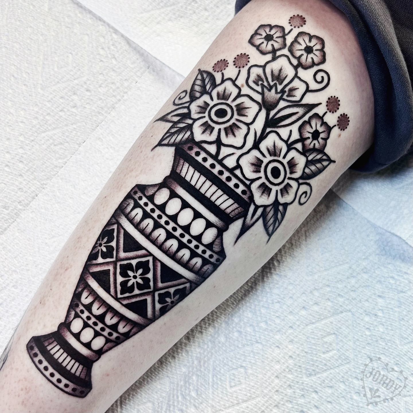 Vase with flowers black and grey tattoo on the forearm by jordy, Philadelphia, Pennsylvania