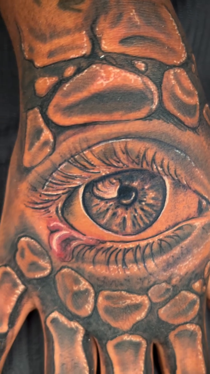 Eye and bones realism tattoo by Jakobi