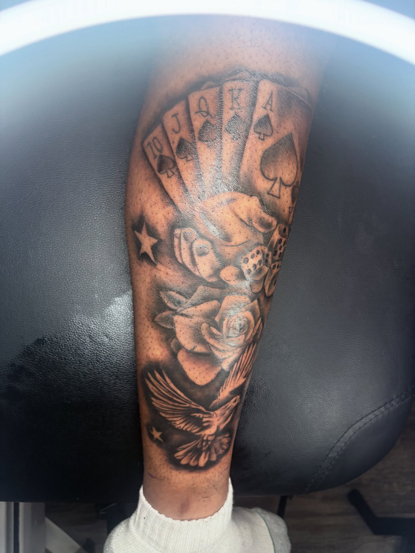 Playing cards and roses realism tattoo on the forearm by Maleek Inkz