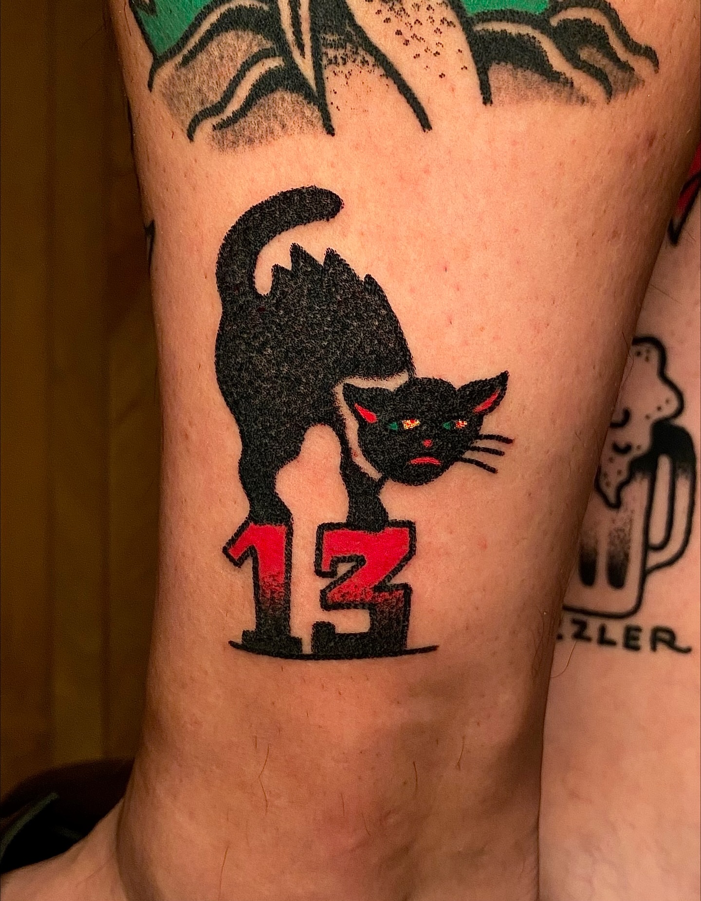 Black cat American traditional tattoo on the forearm by Daniel Diego