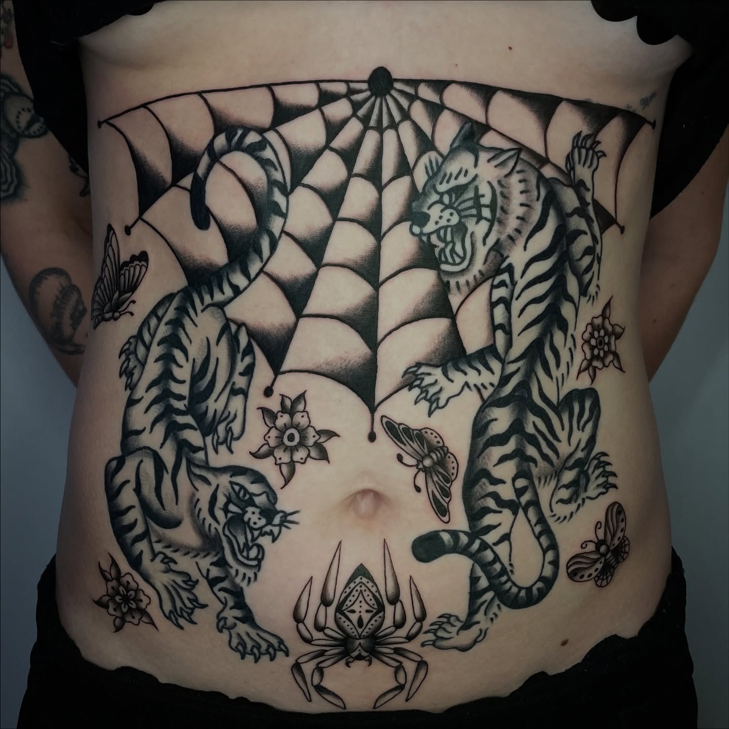 Tiger and spider geometric tattoo on the torso by Sophia Tattoo