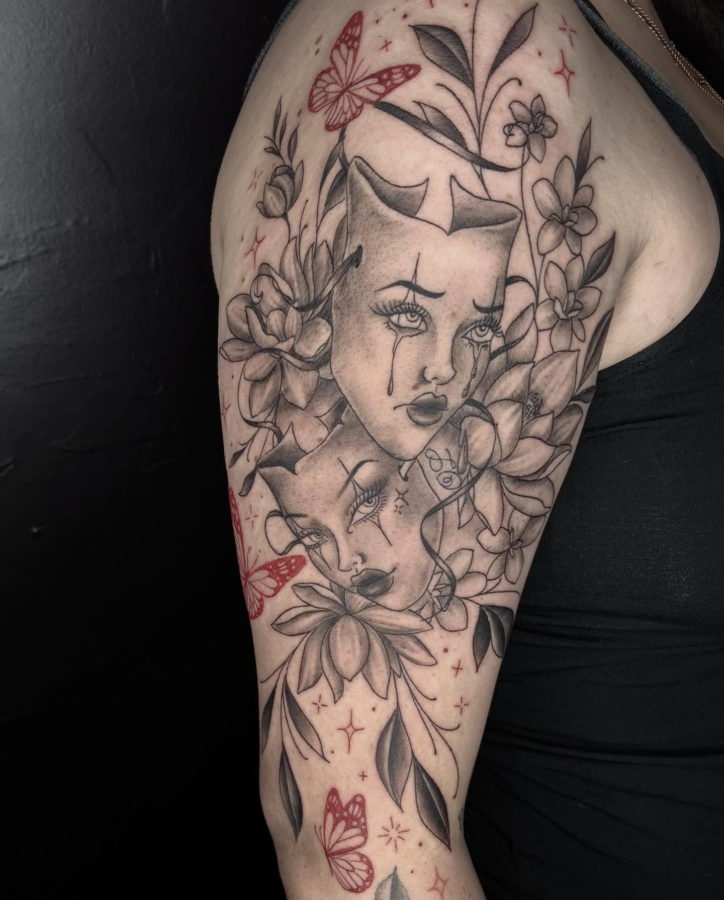 Woman's face with flowers realism tattoo on the upper arm by Kat π