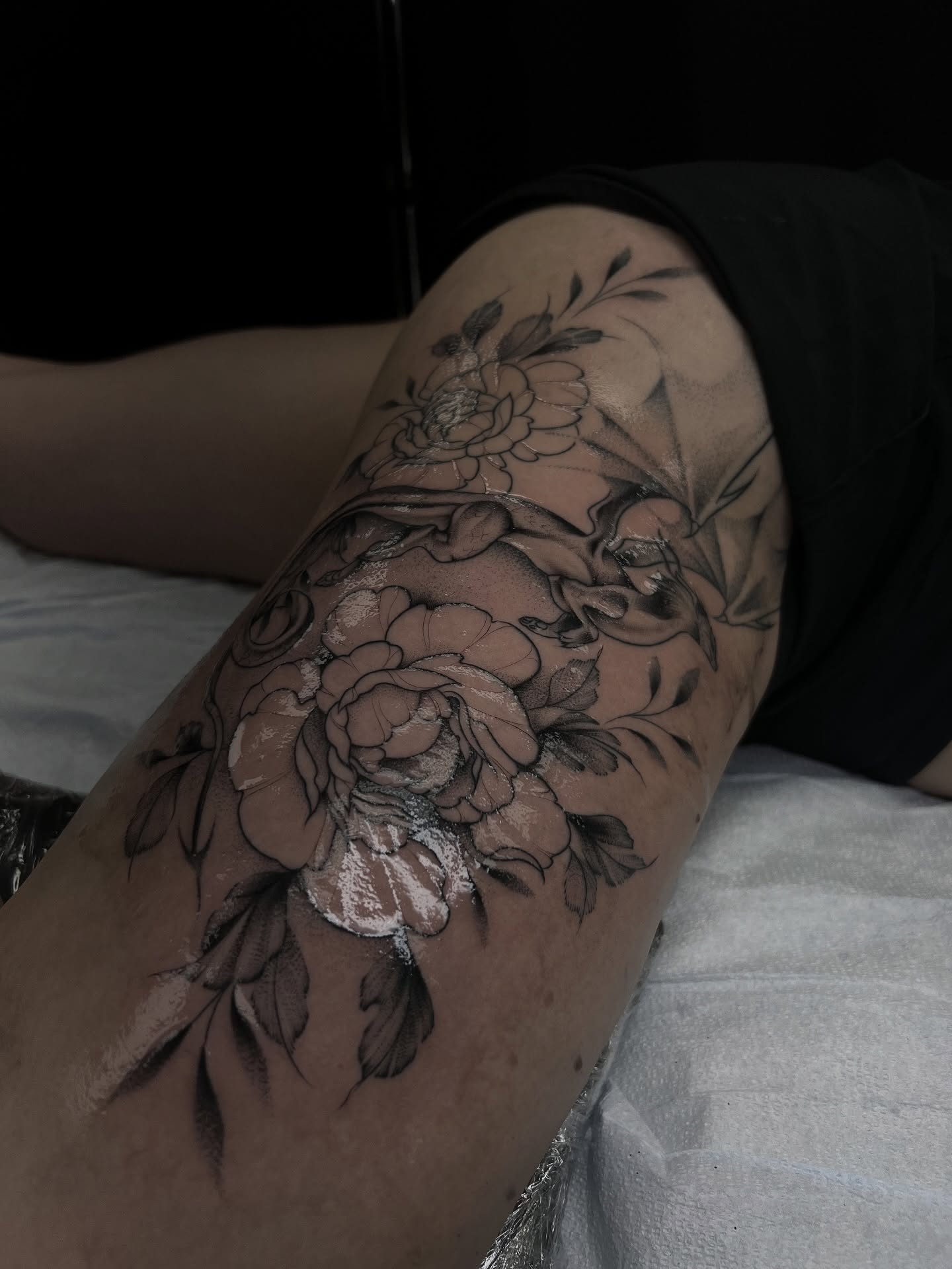 Peony flowers black and grey tattoo on the thigh by Chloe