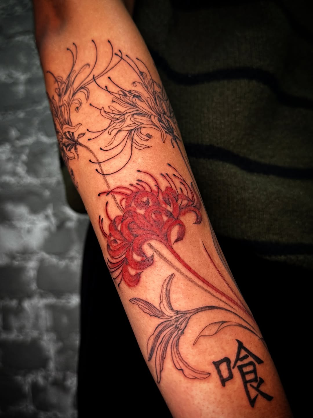 Spider lilies and kanji tattoo on the forearm by Nyc Tattoo Manhattan