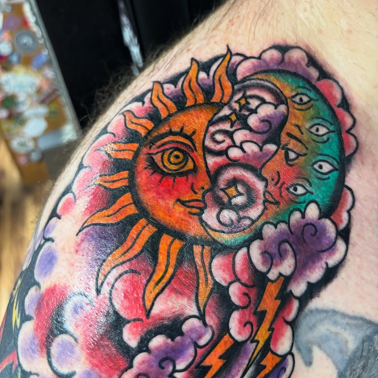 Sun and moon American traditional tattoo on the upper arm by 18 and older High End Tattoo
