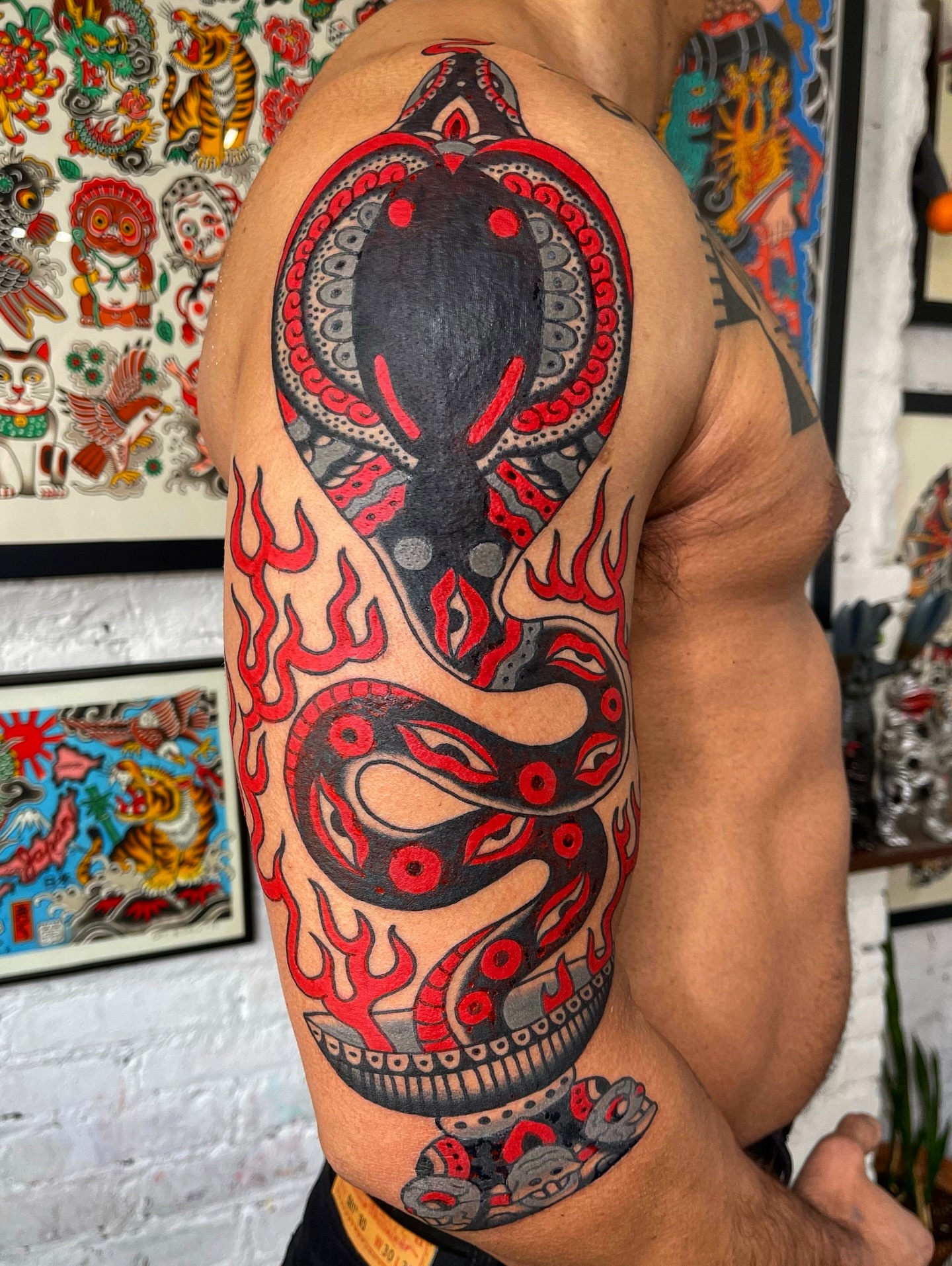 Snake American traditional tattoo on the upper arm by Swasthik Iyengar, New York, New York