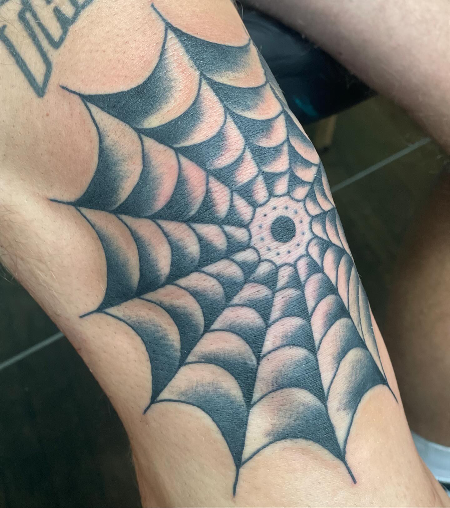 Spider web geometric tattoo on the forearm by Haley McMahon