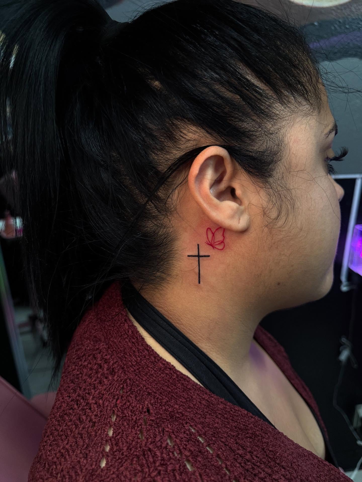 Cross and butterfly fine line tattoo on the neck by Jasmin Lozano