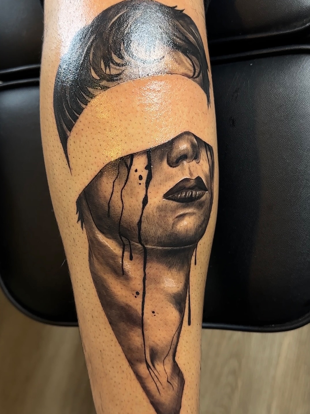 Blindfolded face with dripping ink realism tattoo on the forearm by 🐺